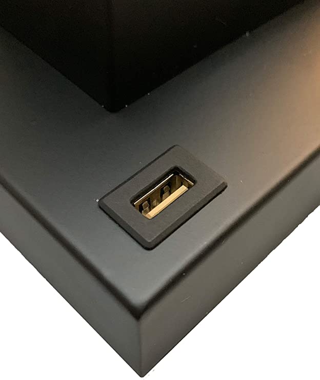 Closeup of black rectangular device featuring a goldlined USB port ideal for charging electronics