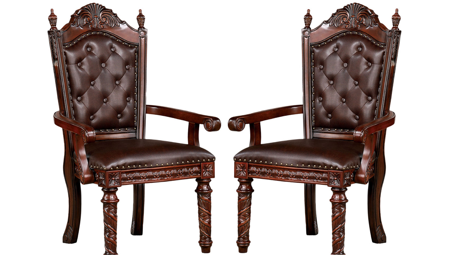 Two ornate brown leather tufted armchairs with carved wooden legs ideal for a dining room