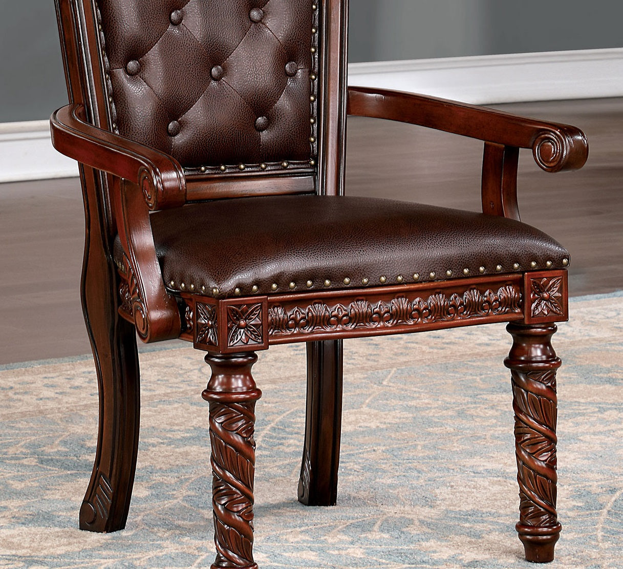 Ornate tufted brown leather armchair with carved mahogany wood frame classic style