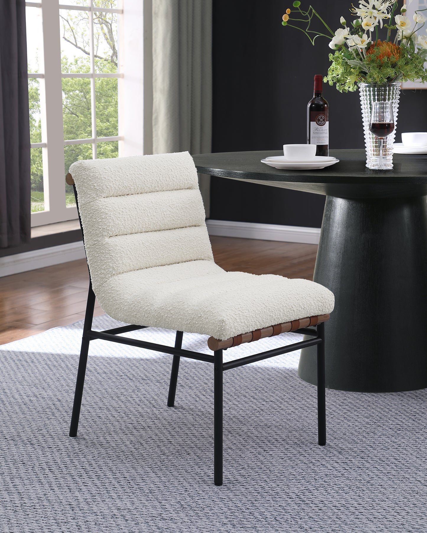 Cream boucl dining chair with black metal frame and wood accents