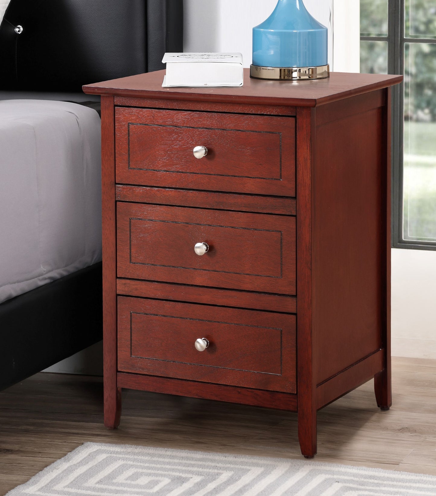 Wooden nightstand with three drawers in a cherry finish and silver knobs