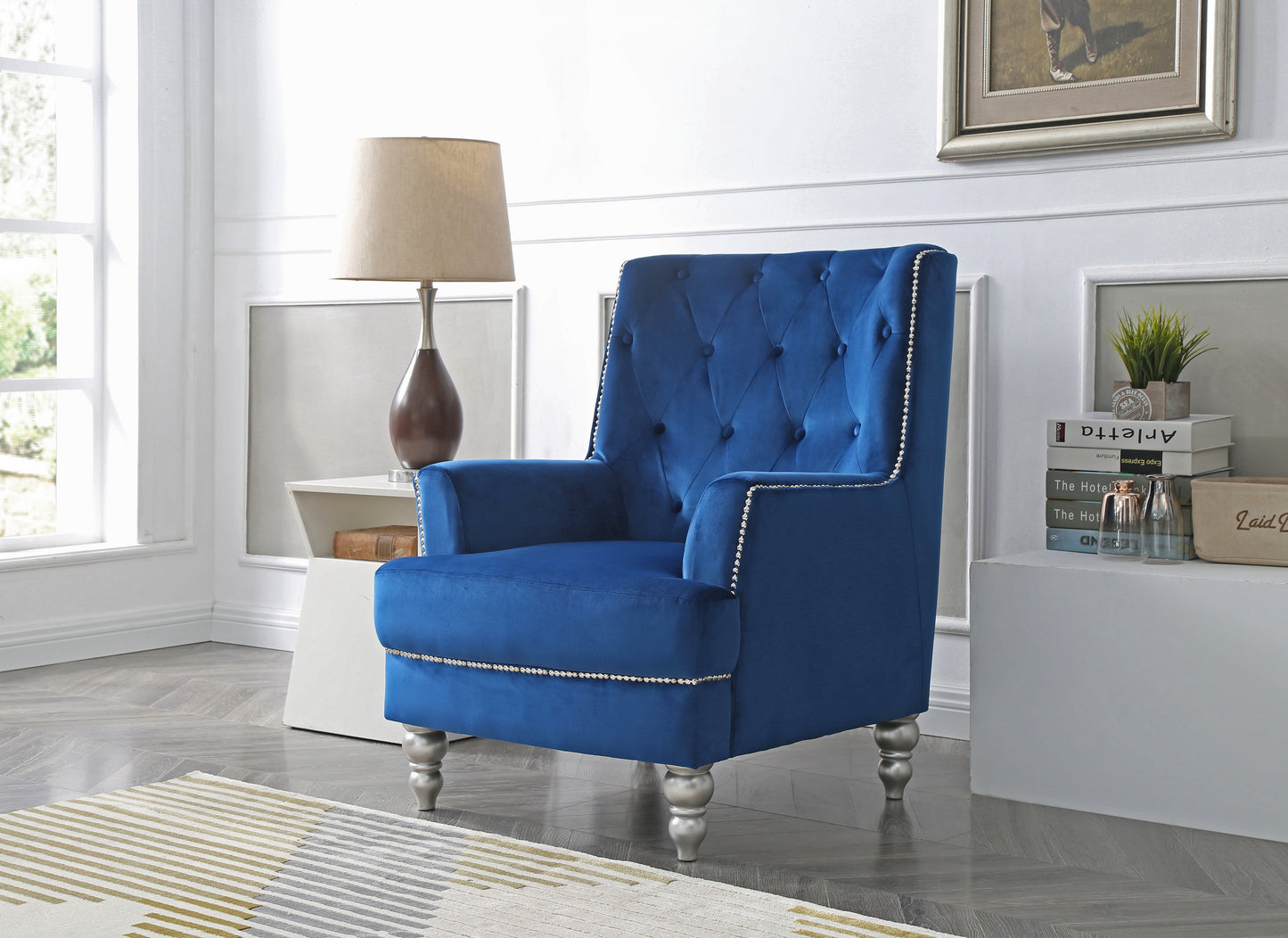 Deep blue velvet accent chair with tufted back and silver nailhead trim