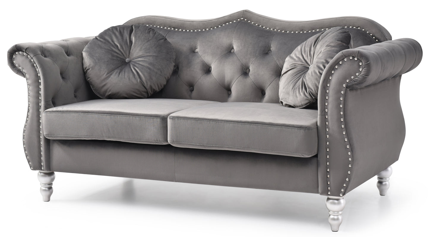 Grey velvet chesterfield loveseat with decorative silver nailhead trim and plush cushions