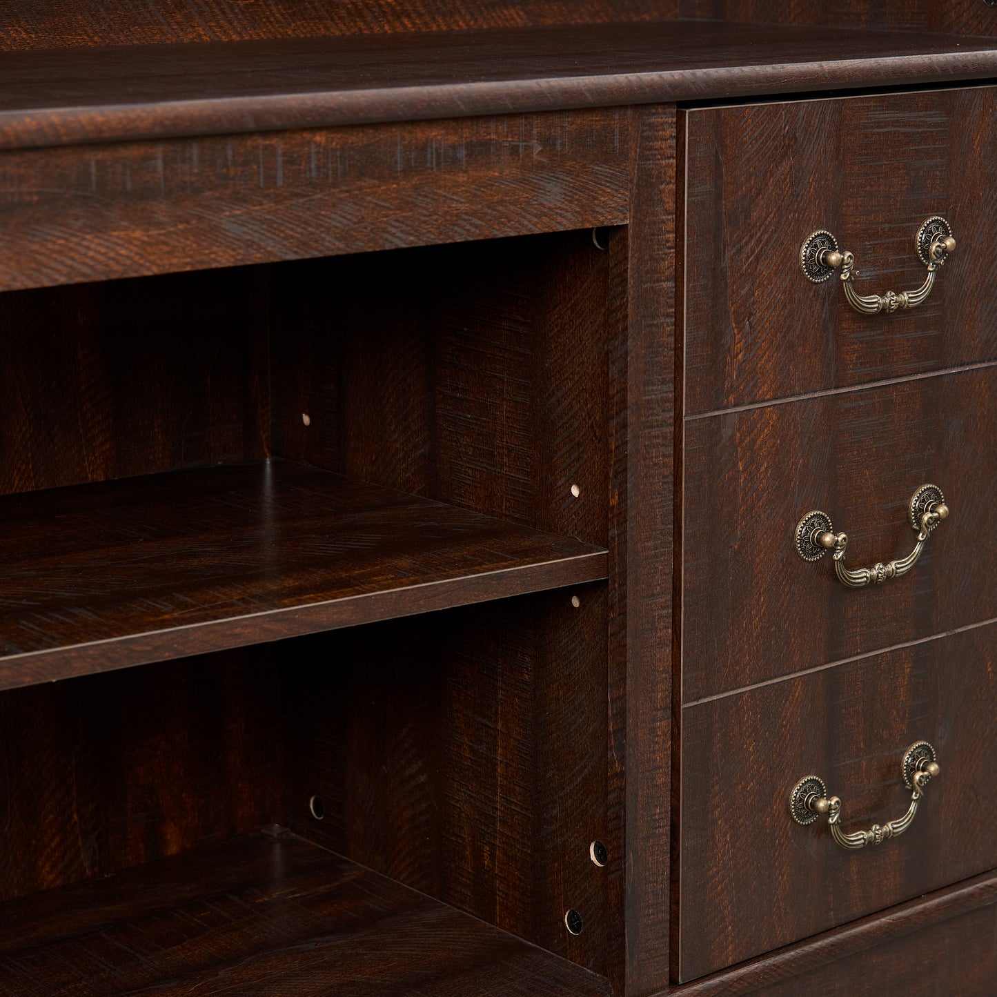 Dark wood dresser with three ornate brass drawer pulls and open shelving
