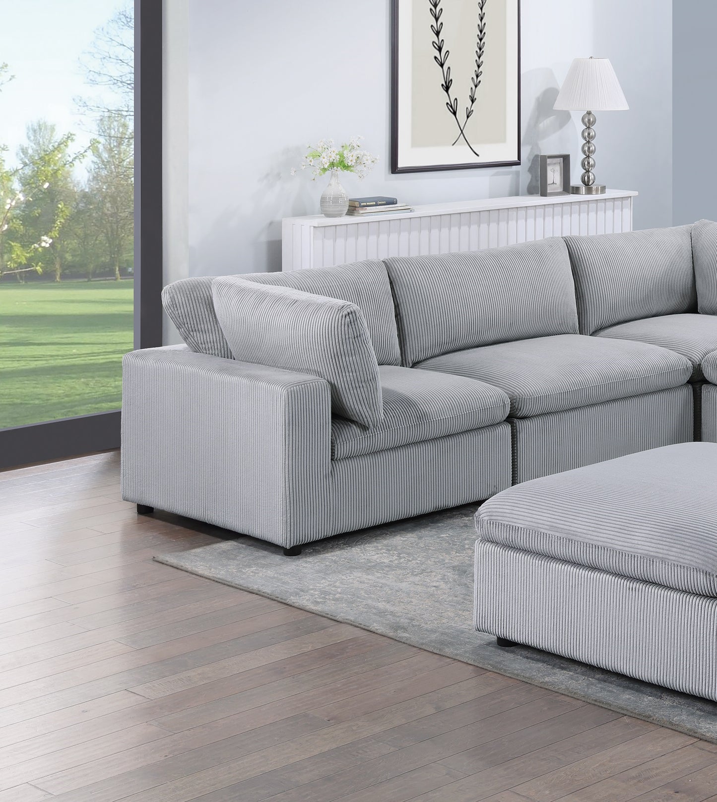 Plush grey corduroy sectional sofa with matching ottoman perfect for modern living rooms