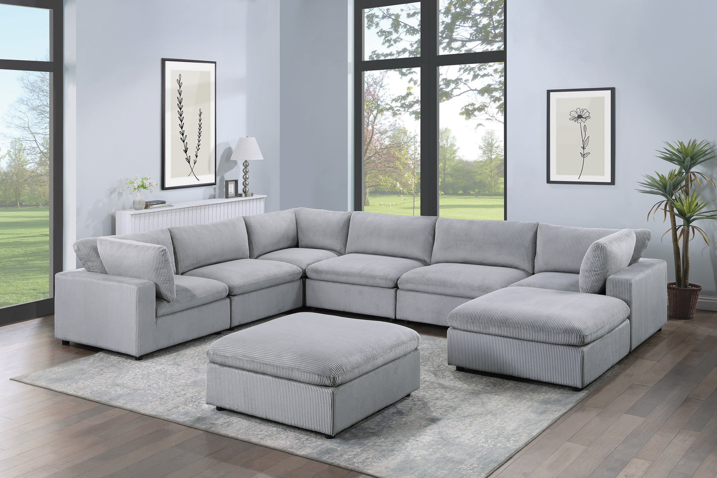 Light grey corduroy sectional sofa with matching ottoman on a patterned rug
