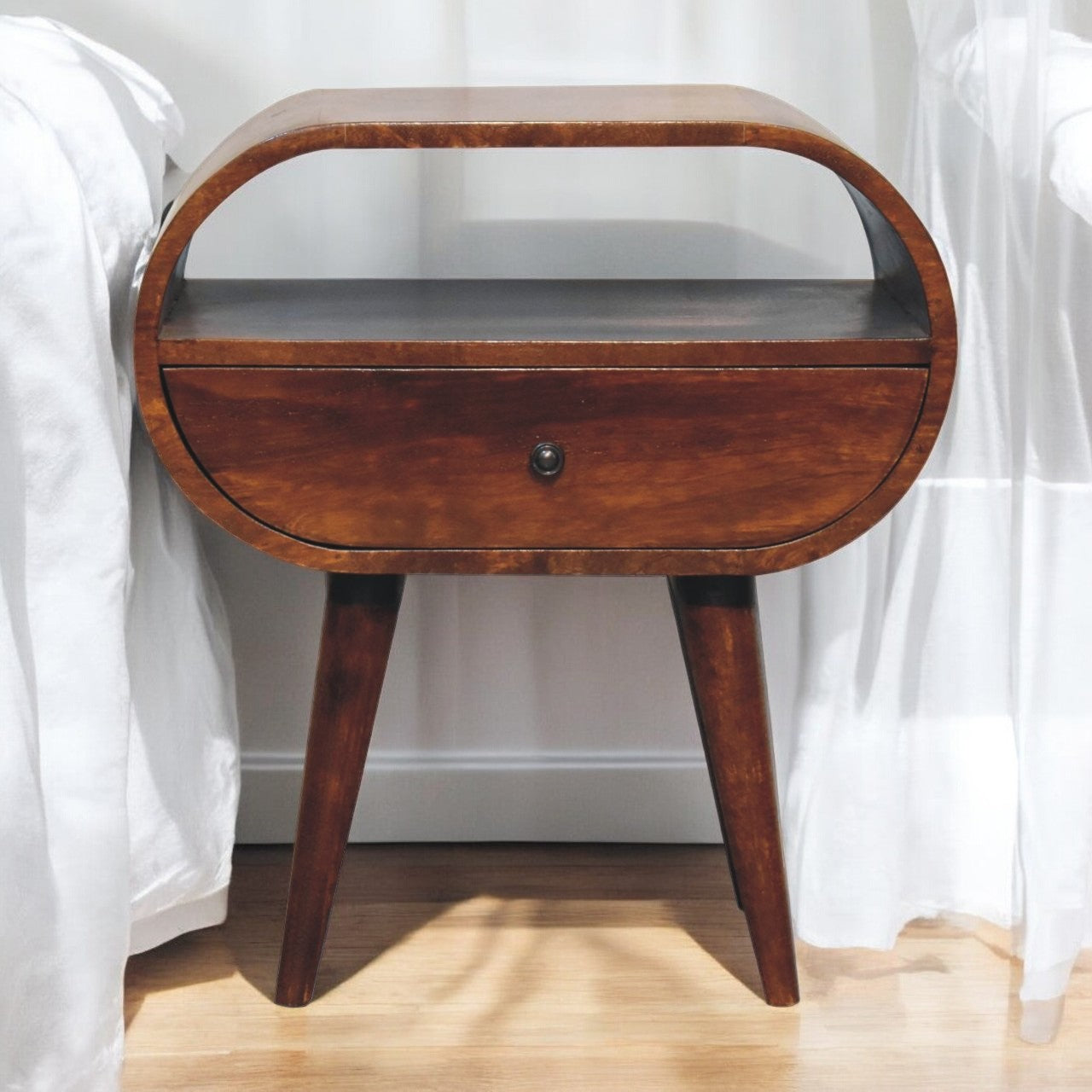 Oval wood nightstand with single drawer and tapered legs