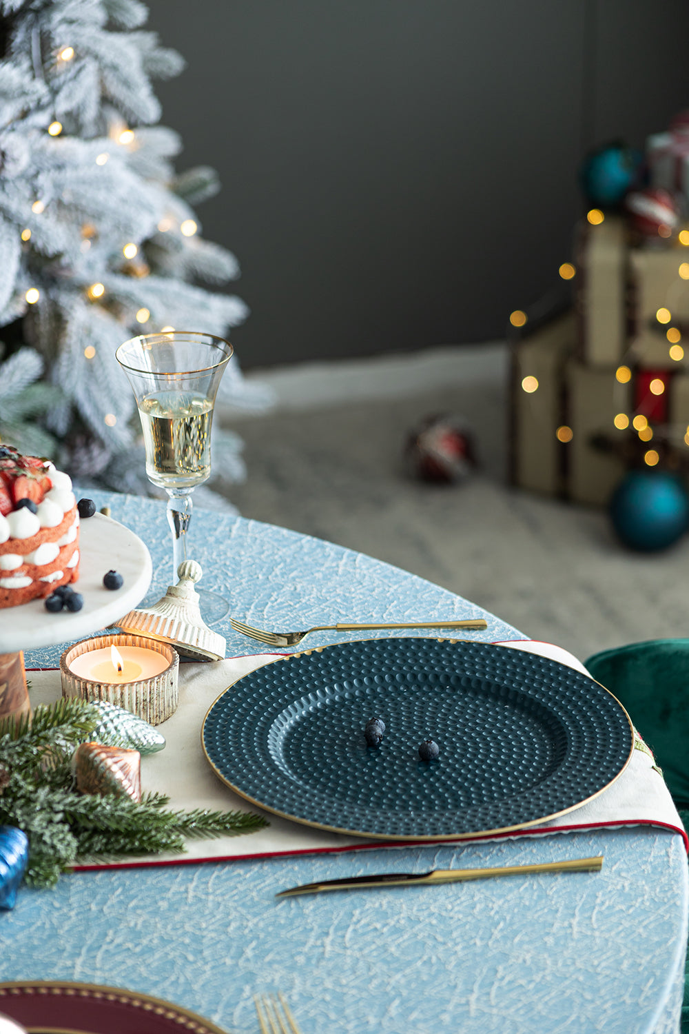 Deep blue textured charger plate with gold rim set for a festive meal