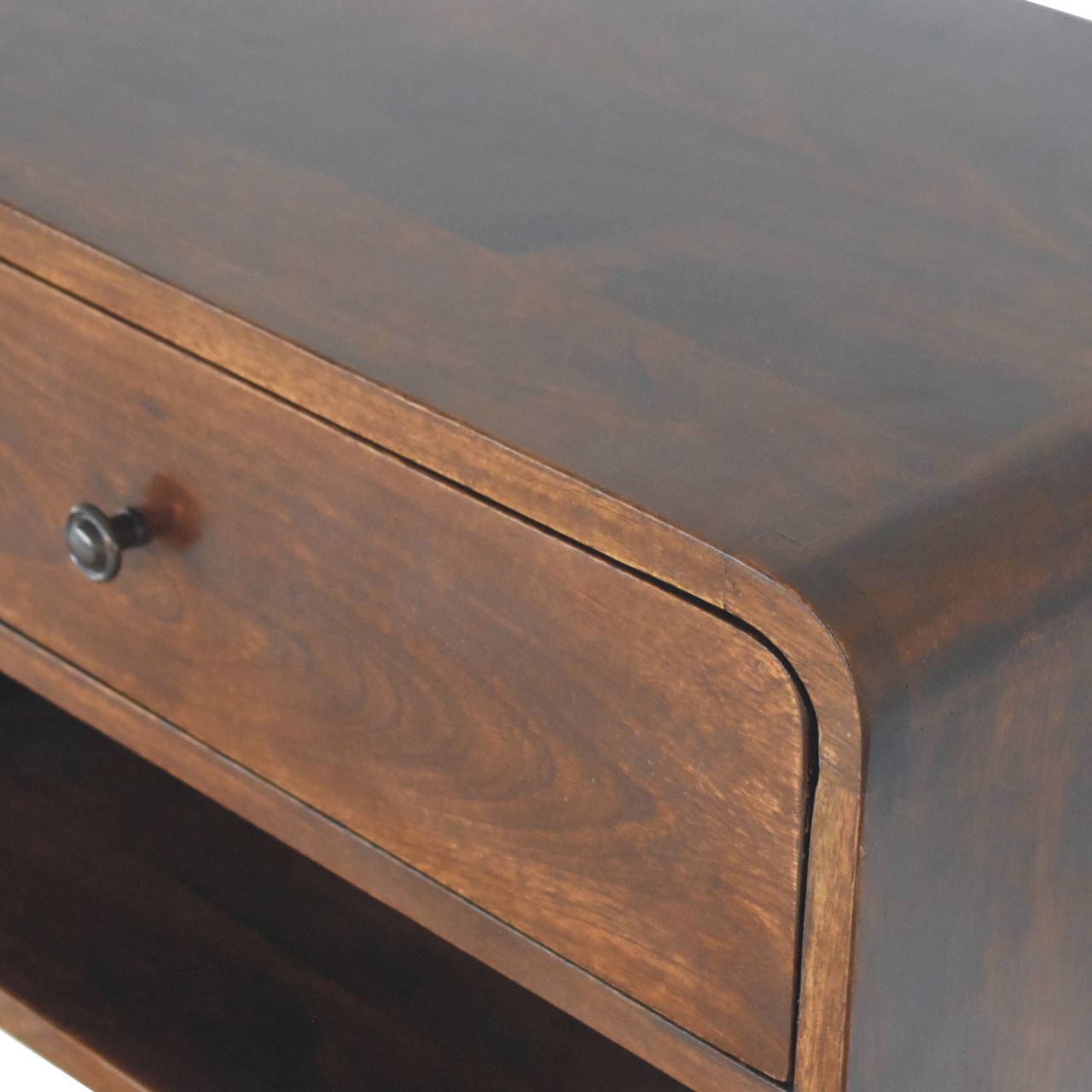 Dark wood accent cabinet with curved edges and antique knob detail