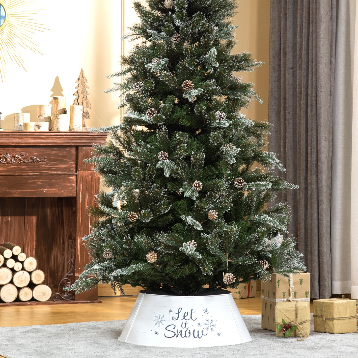 Frosted artificial Christmas tree with pinecones and a white Let it Snow tree skirt