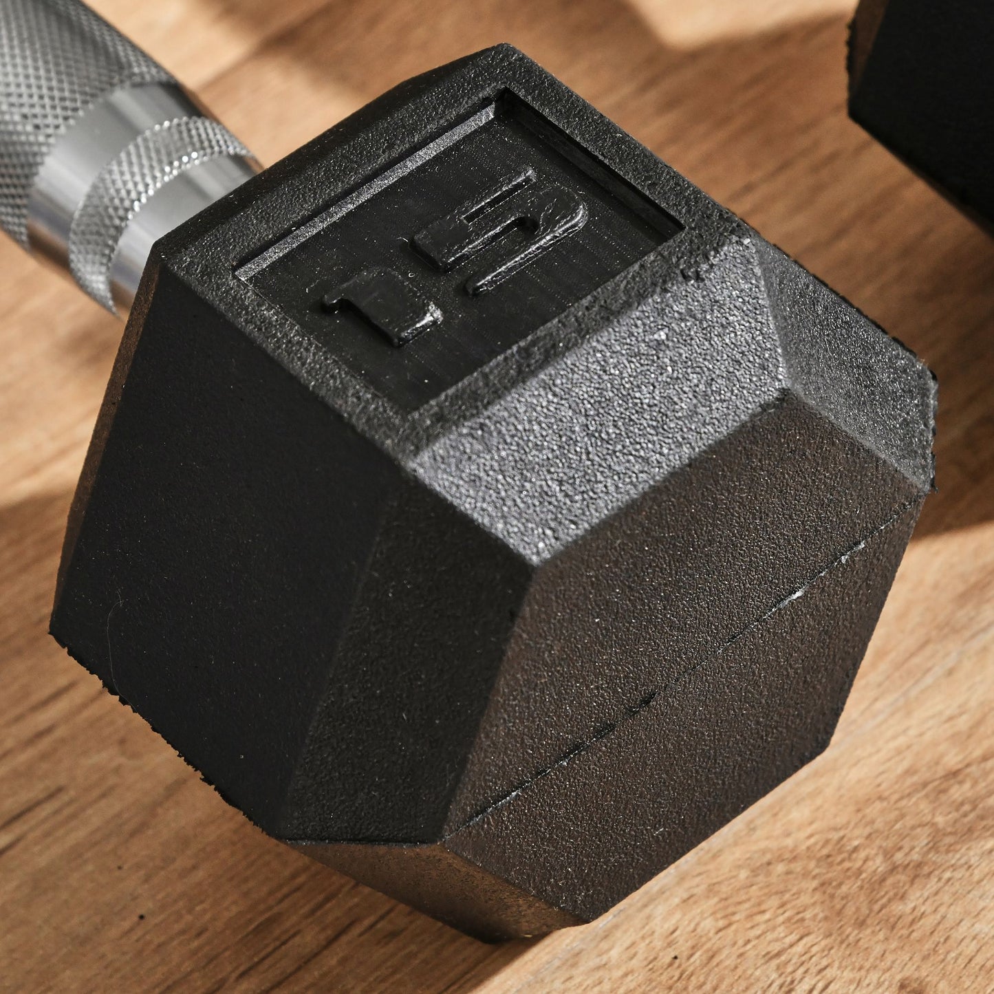Black hex dumbbell with lb weight marking on textured head