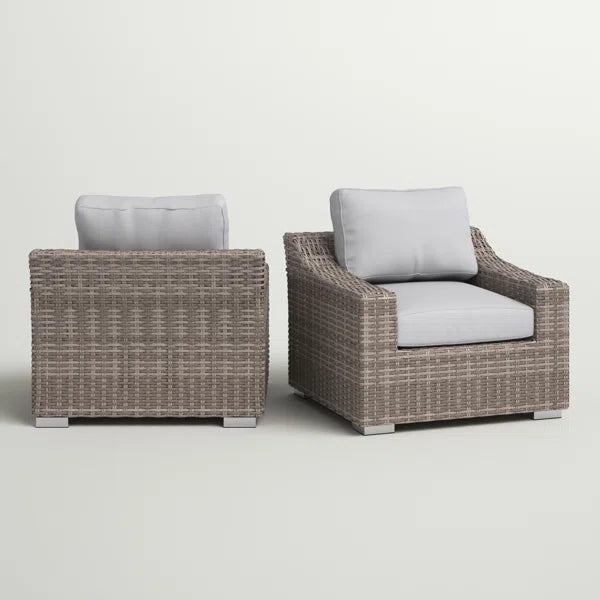 Two taupe wicker club chairs with light gray cushions perfect for outdoor seating