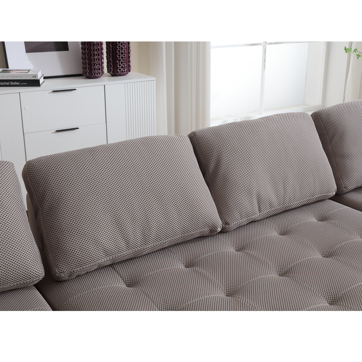 Close up of plush sofa cushions in a neutral textured fabric perfect for living room decor