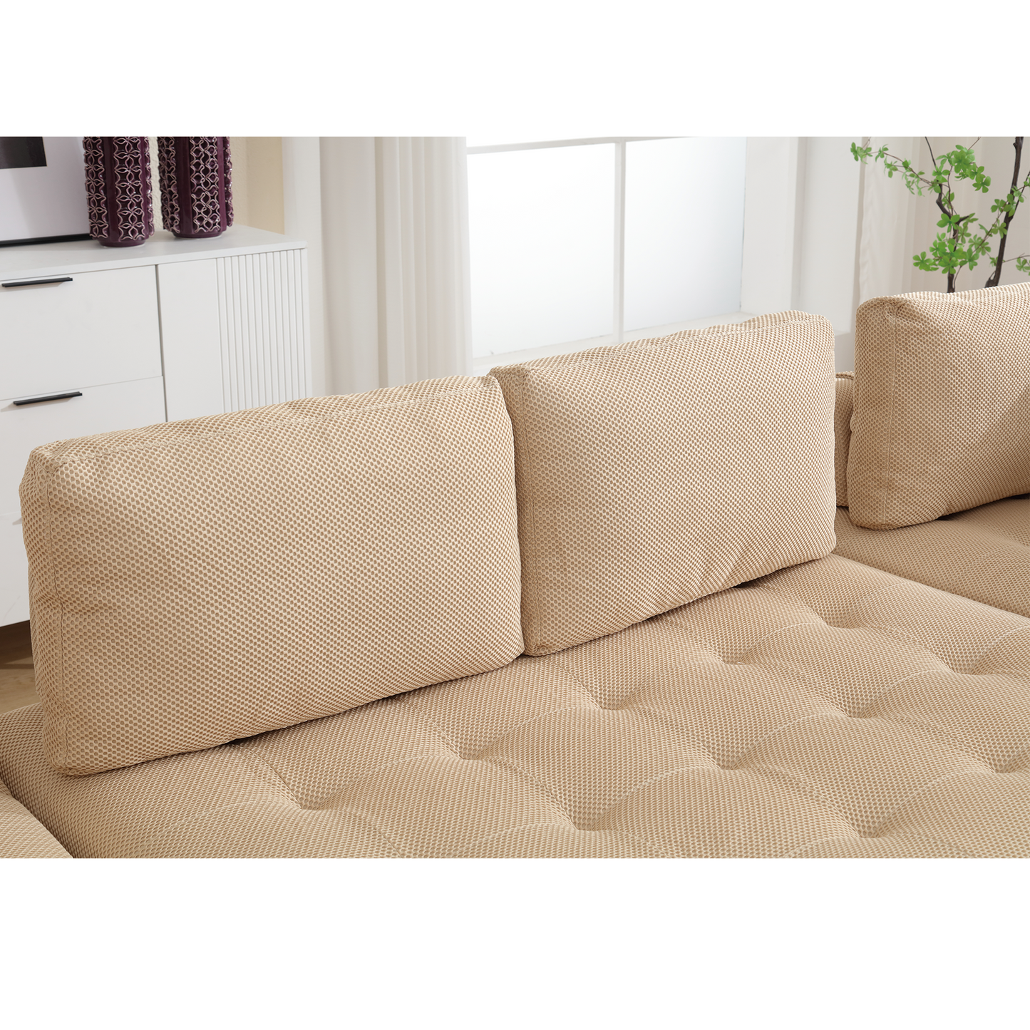 Beige textured fabric sofa with deep button tufting on seat cushions