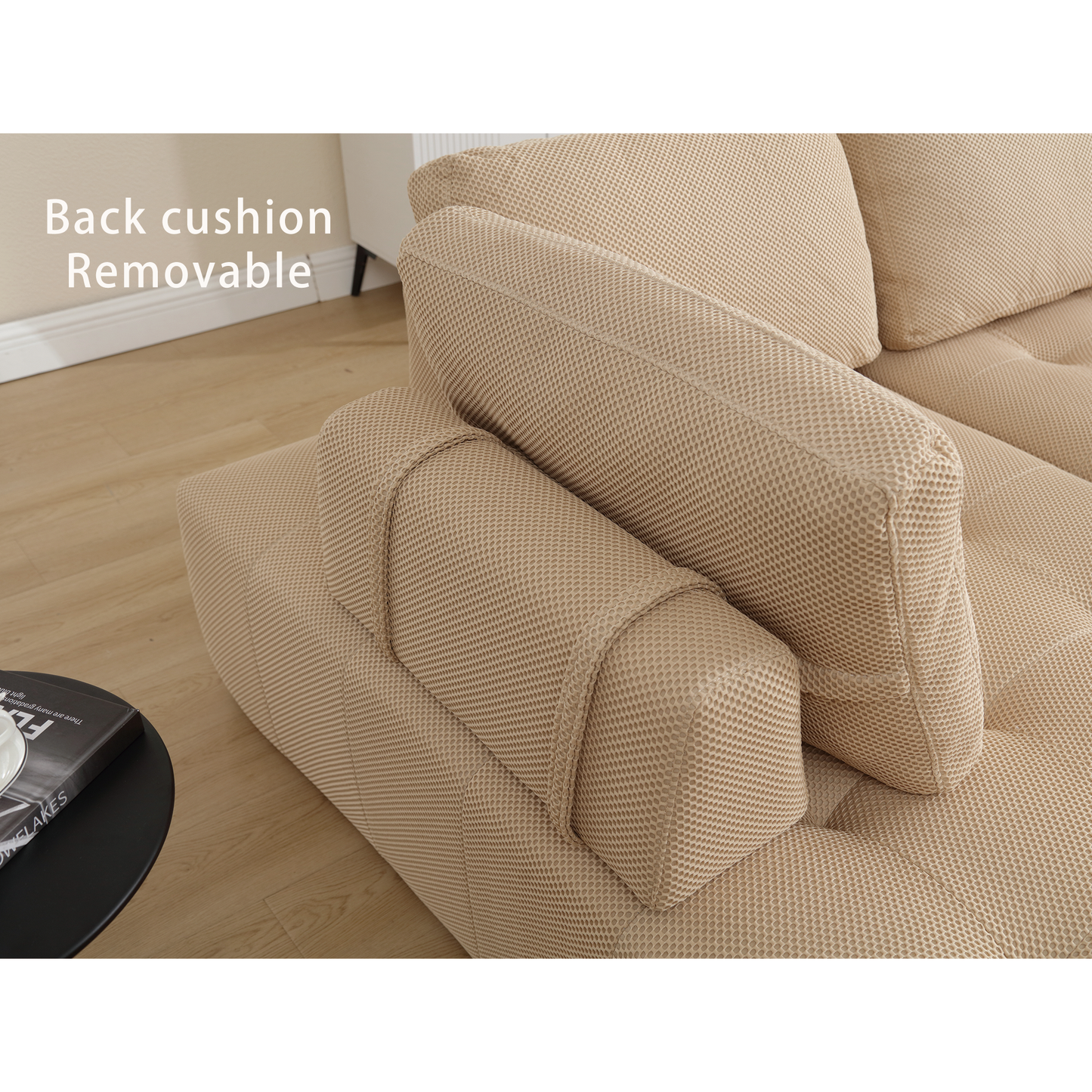 Closeup of a beige linen sectional sofa with removable back cushions and subtle textured fabric