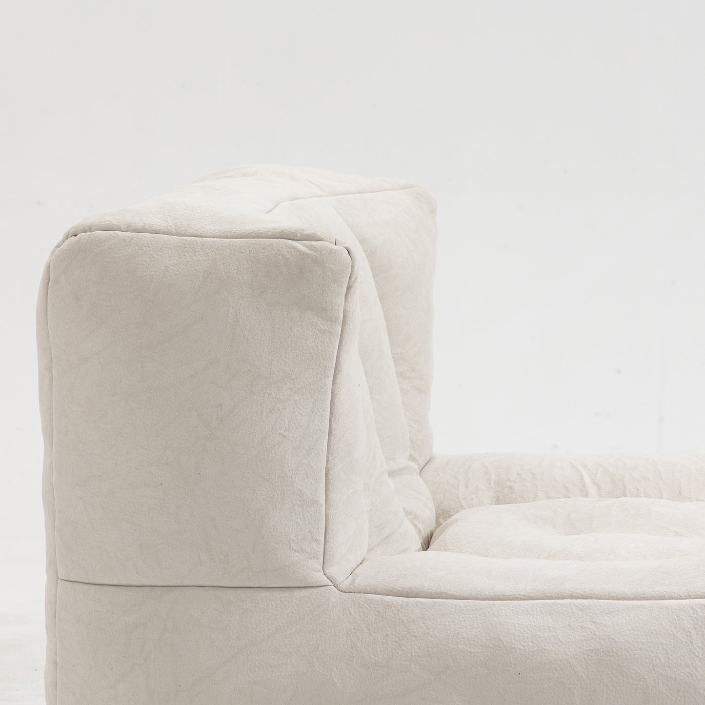 Closeup of a beige linen sofa with textured fabric and plush cushioning perfect for a modern living room