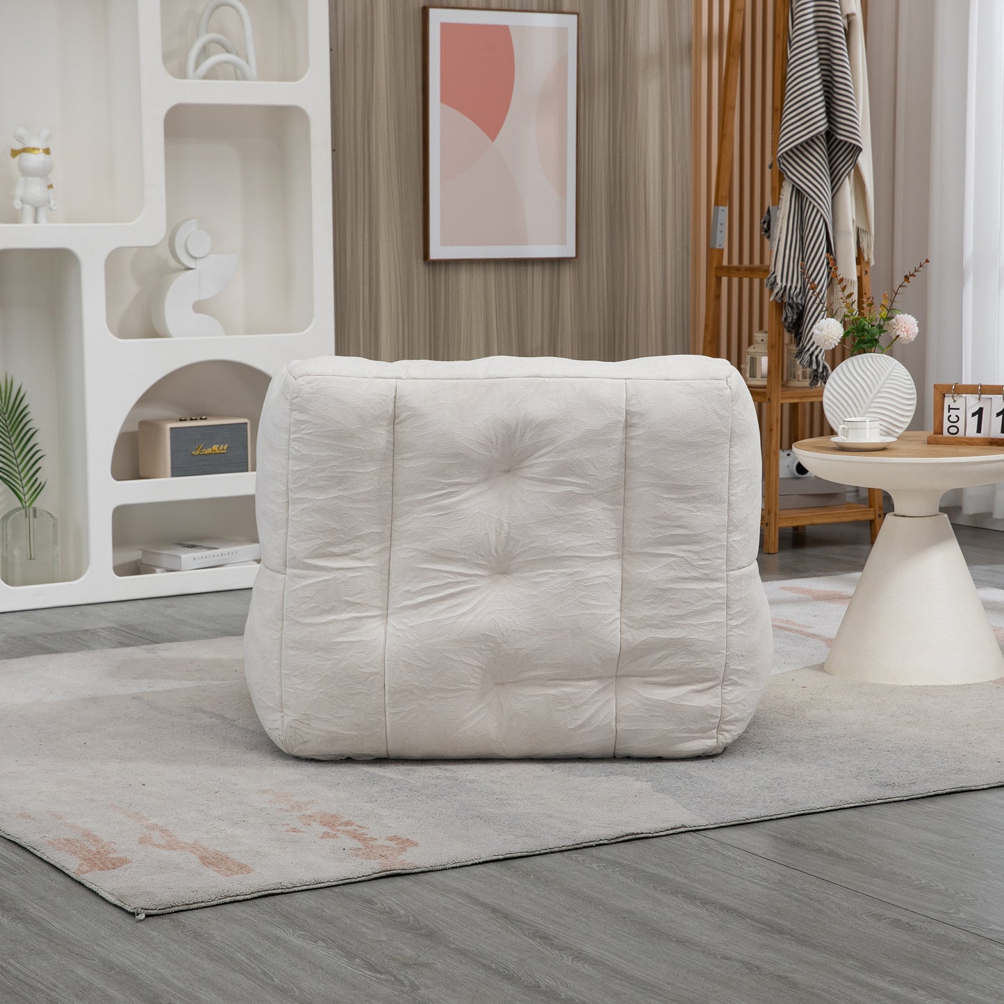 Tufted square pouf in cream textured fabric providing comfortable floor seating for modern living rooms