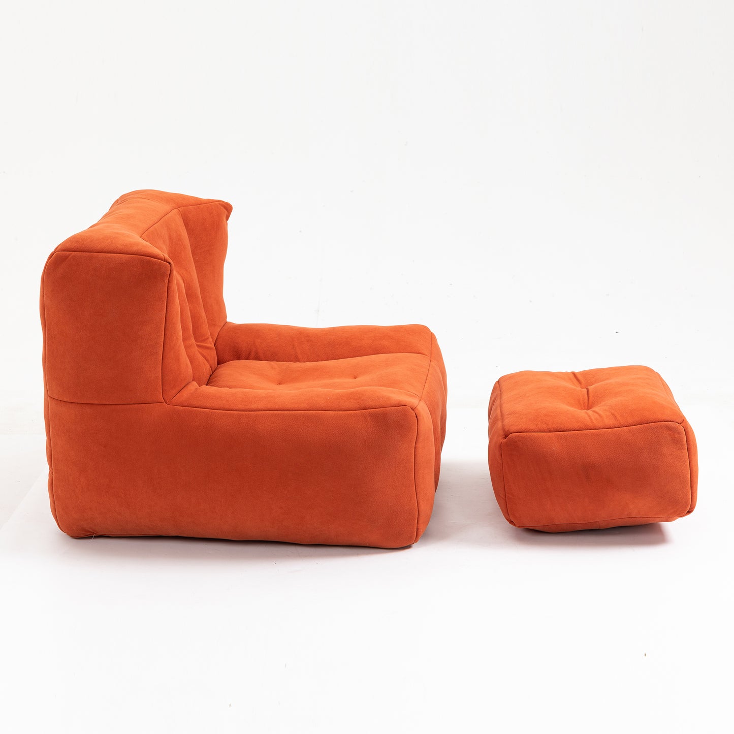Orange modular armchair with button tufting and matching ottoman