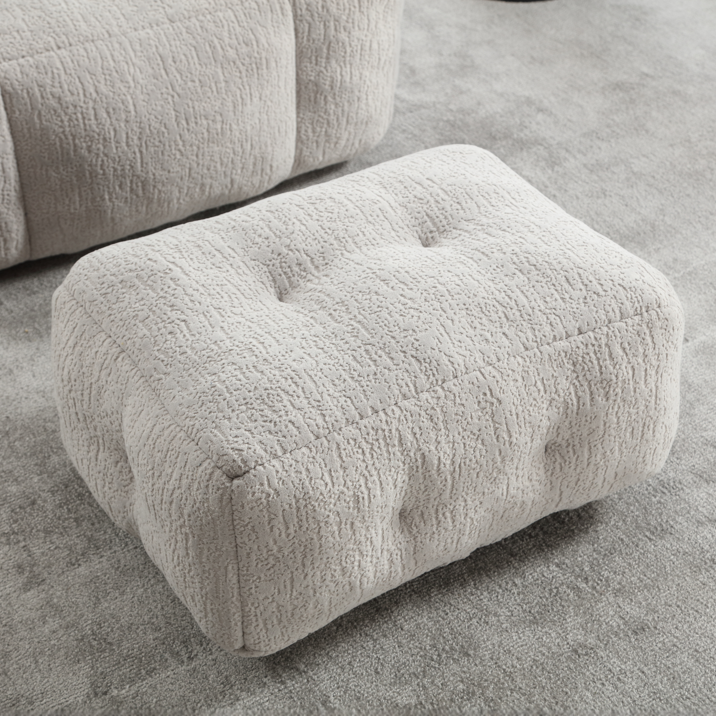 Tufted cream boucle ottoman with textured fabric upholstery perfect for living room footrest