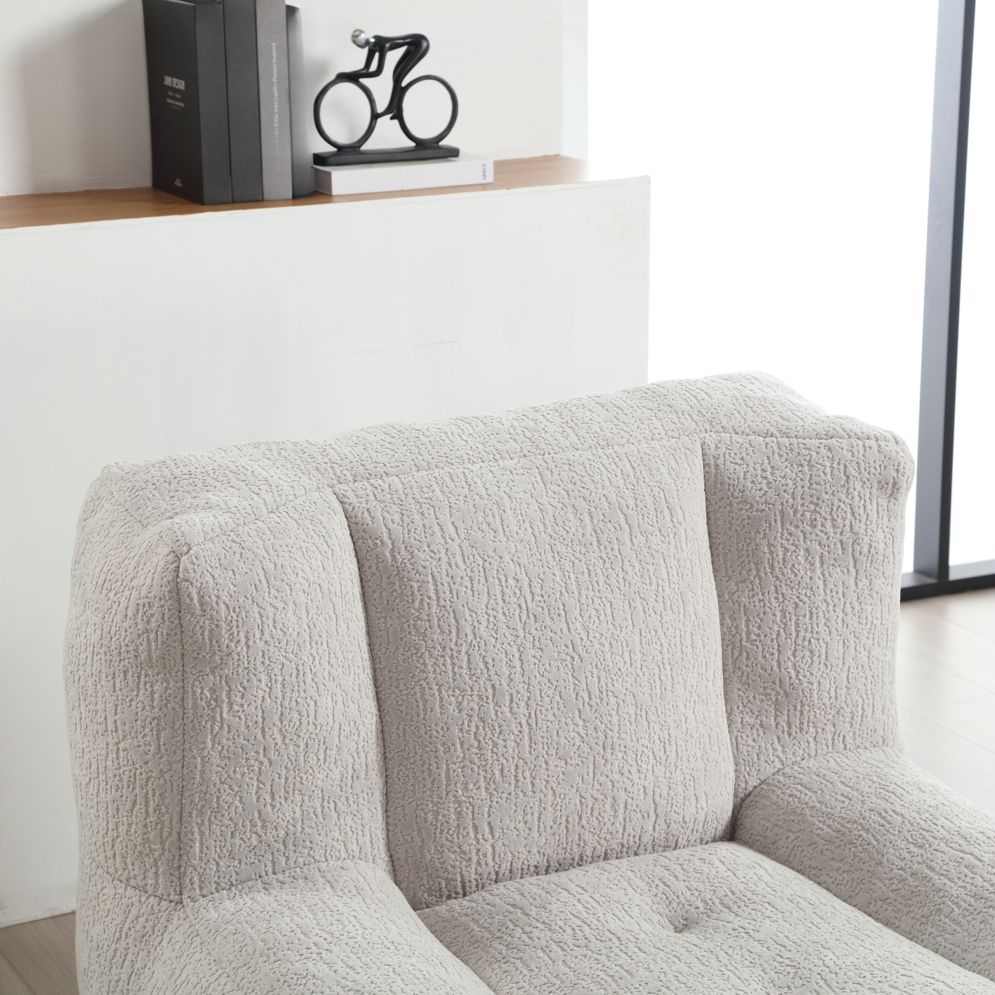Light grey textured armchair with plush cushioning perfect for living room comfort