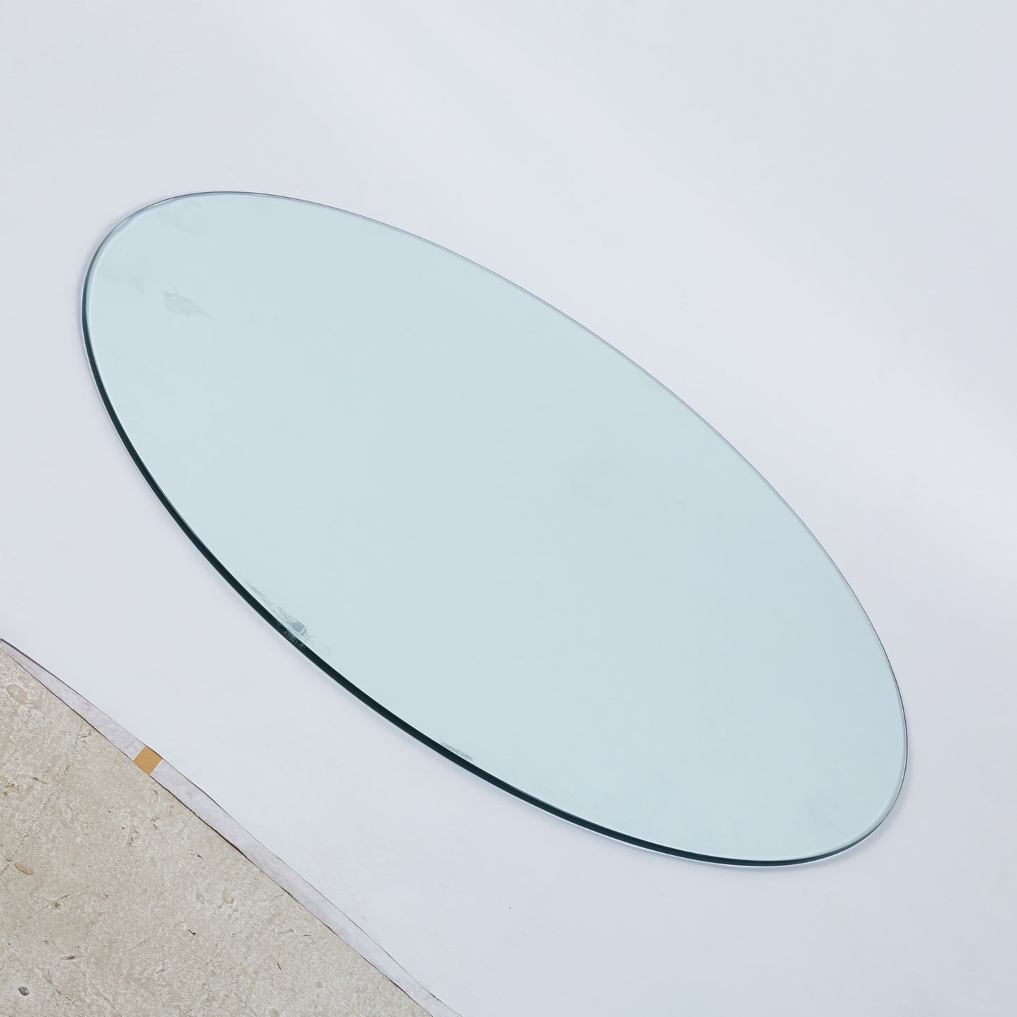 Clear oval glass tabletop with polished edge for dining