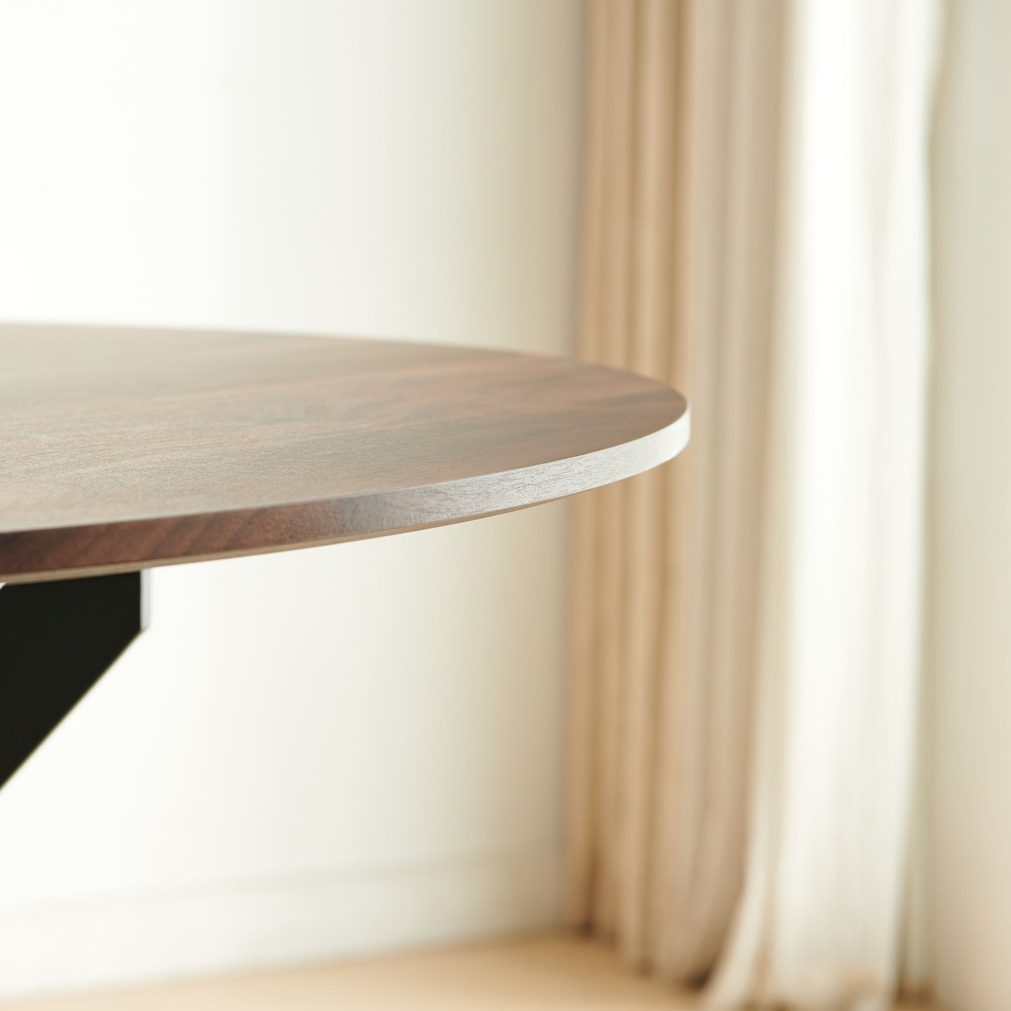 Dark walnut round dining table with clean lines and a modern design