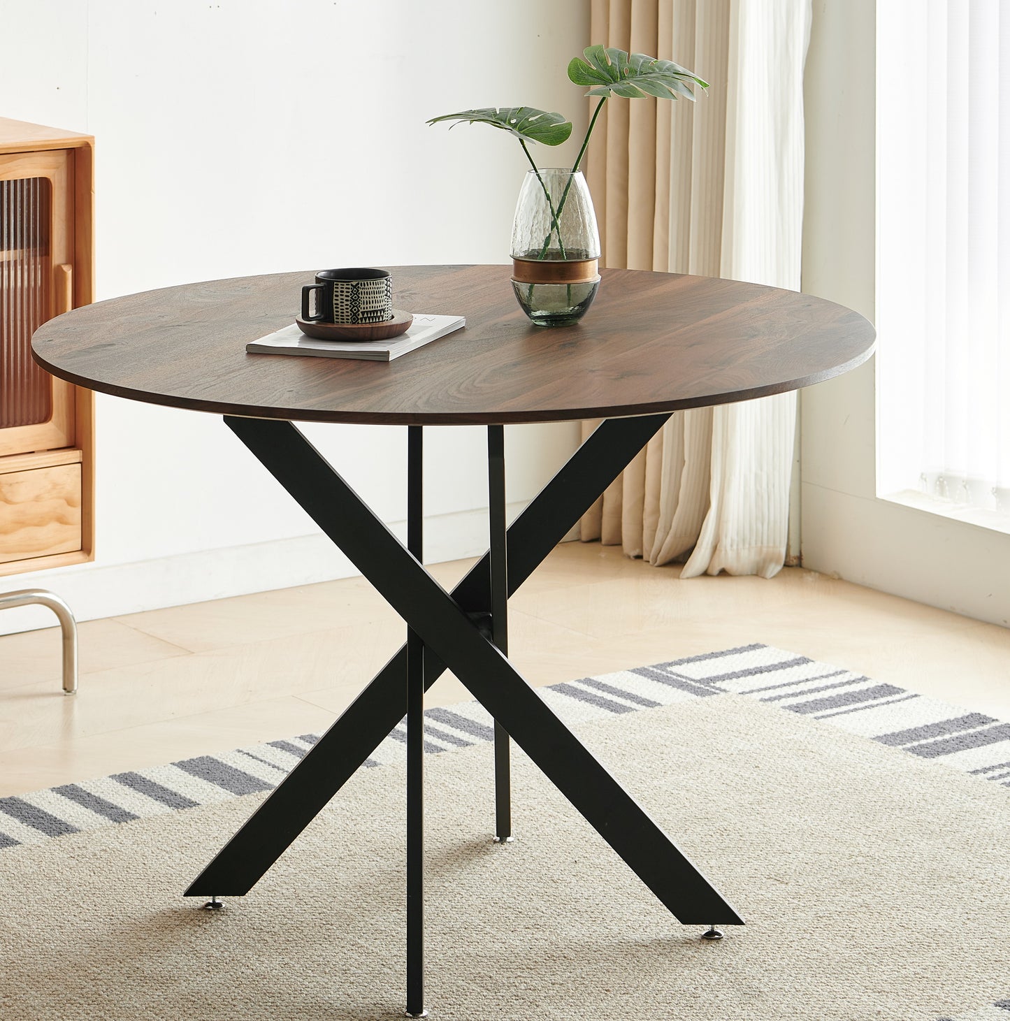 Dark walnut round dining table with black xbase legs modern style for small spaces