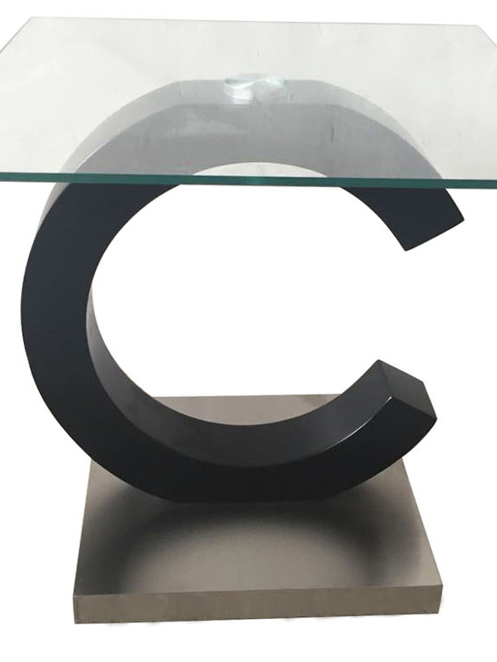 Black Cshaped accent table with clear glass top and brushed metal base
