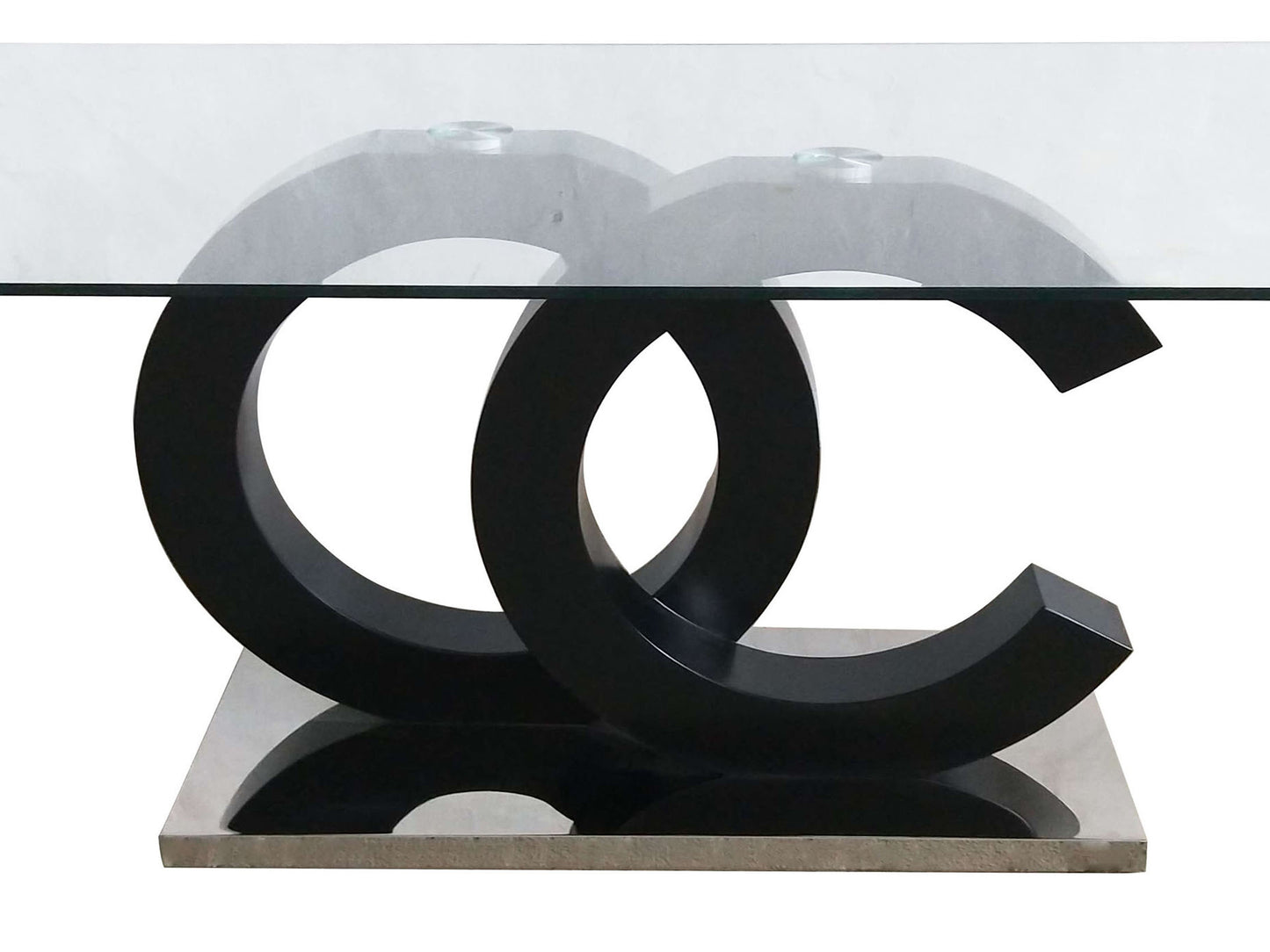 Modern coffee table with clear glass top and black interlinking C shaped base on a brushed metal stand