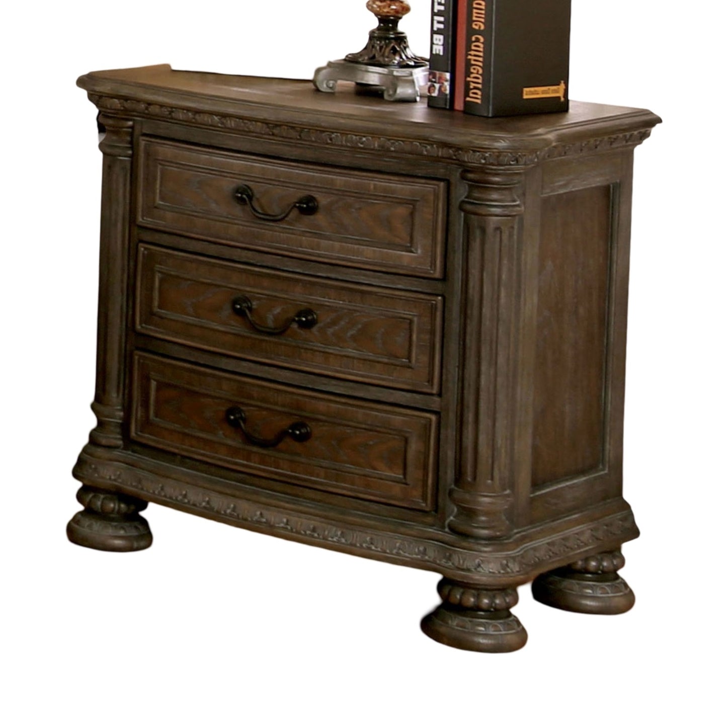 Ornate dark wood nightstand with three carved drawers and decorative legs