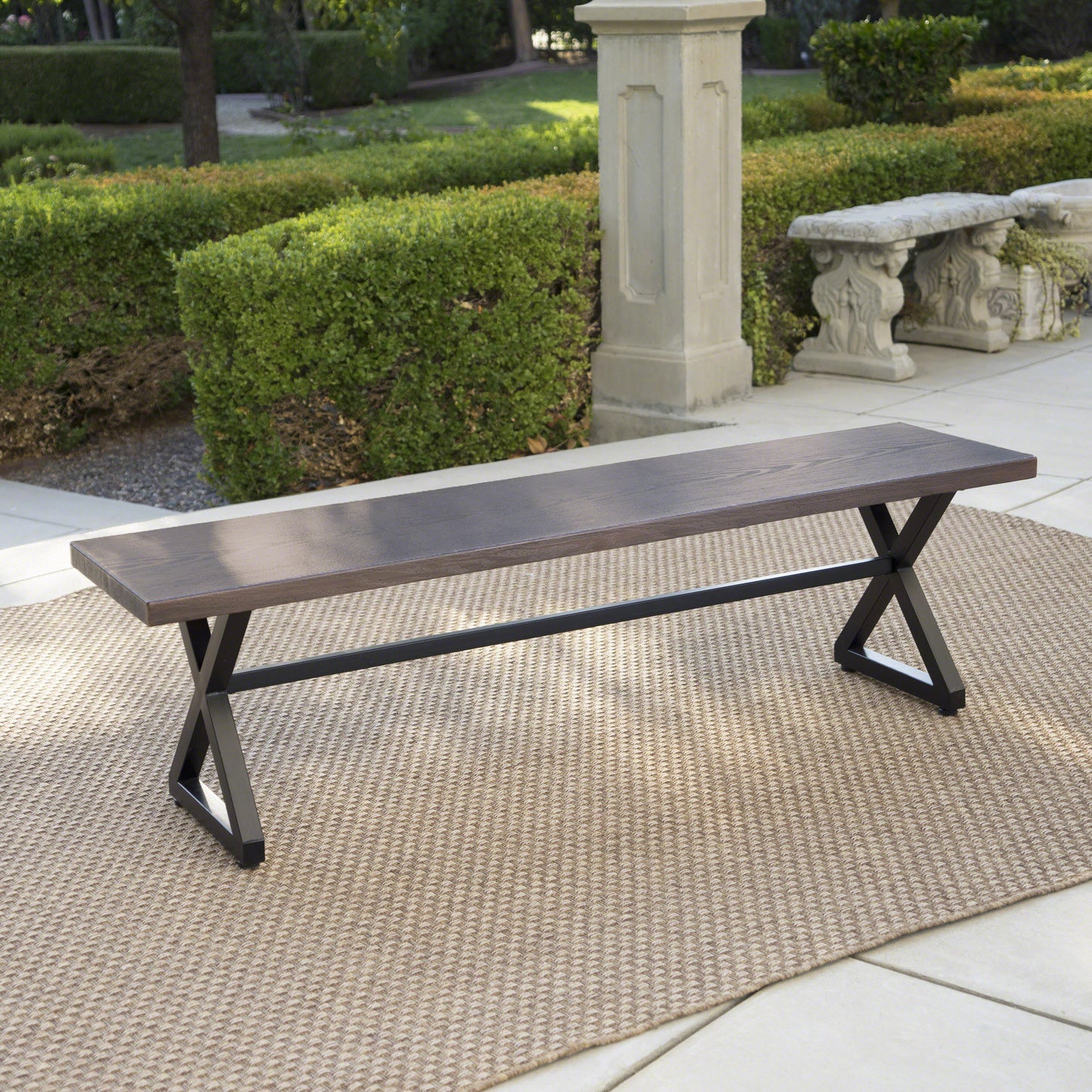 Dark wood and metal outdoor bench with crisscross legs perfect for patio seating