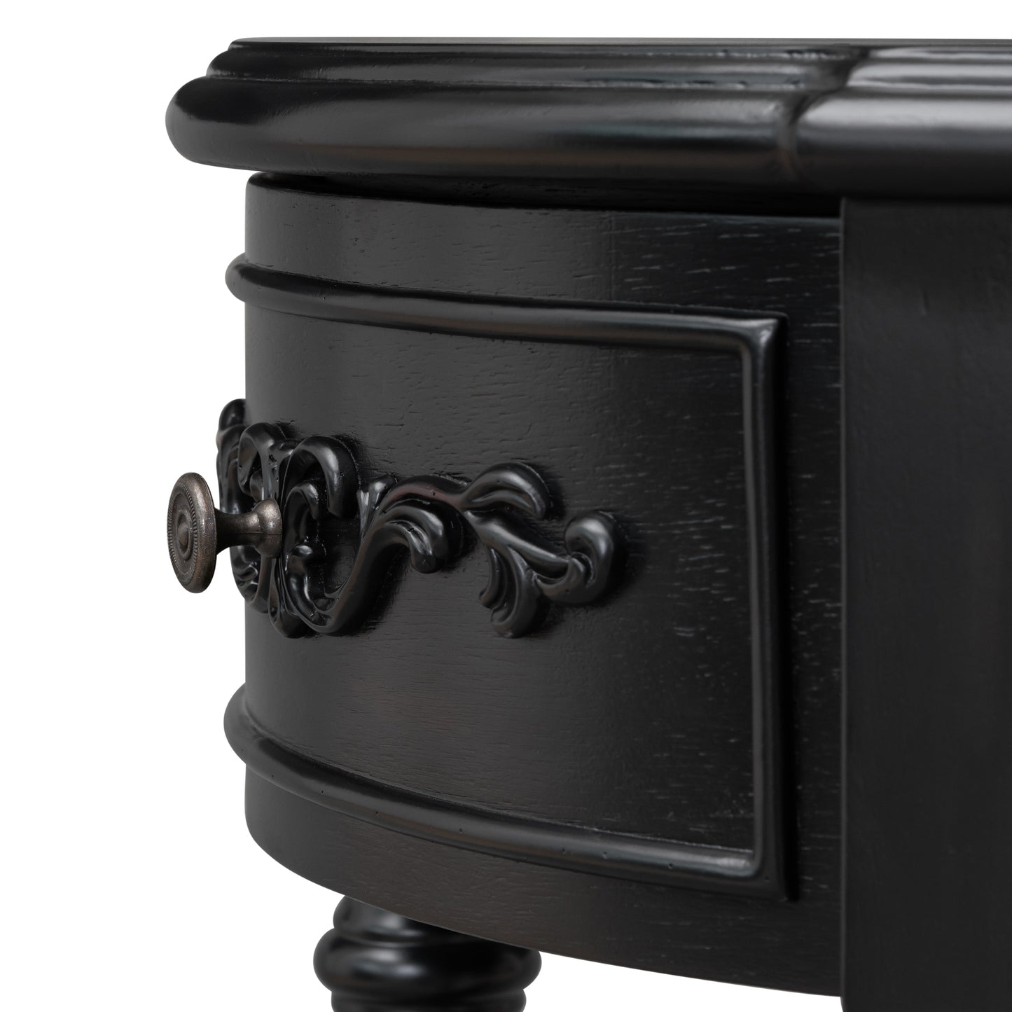 Black ornate drawer pull on a distressed wood side table
