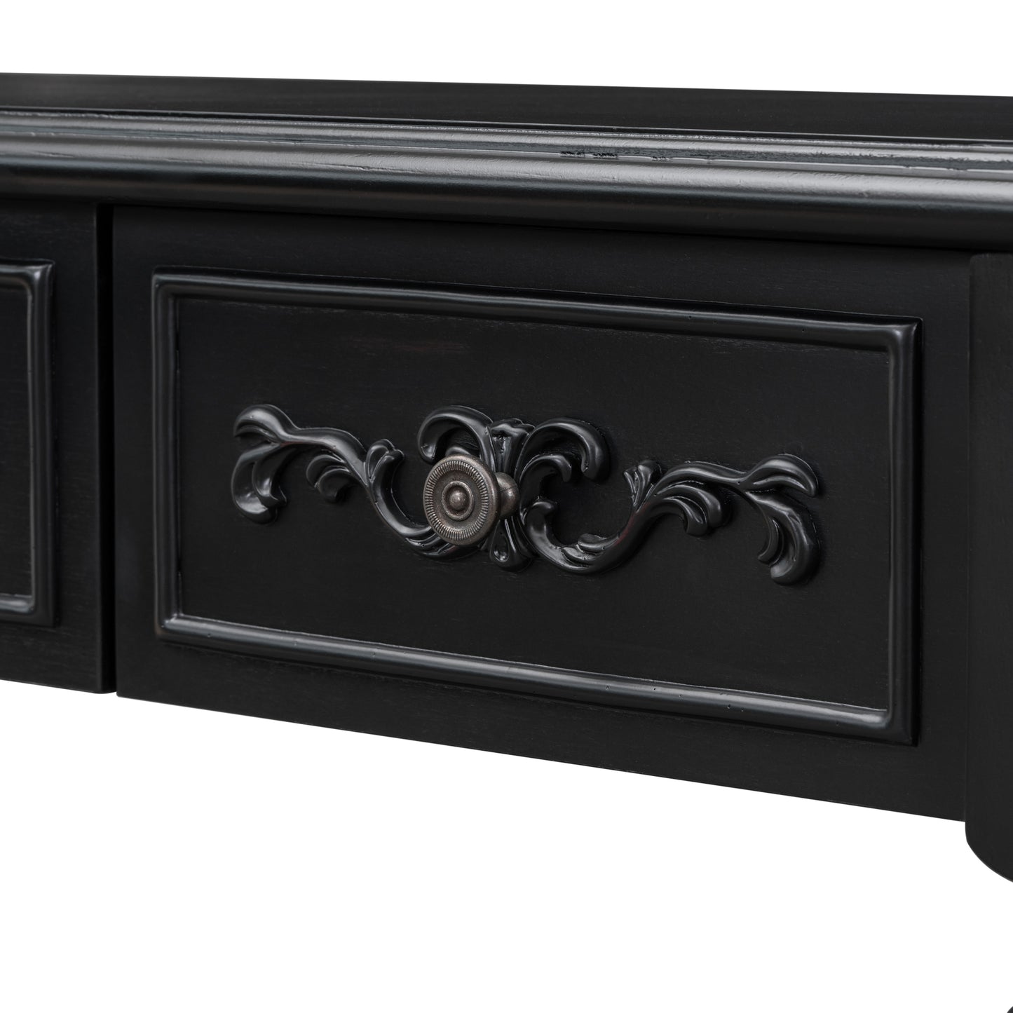 Black ornate drawer pull on a distressed black vanity table