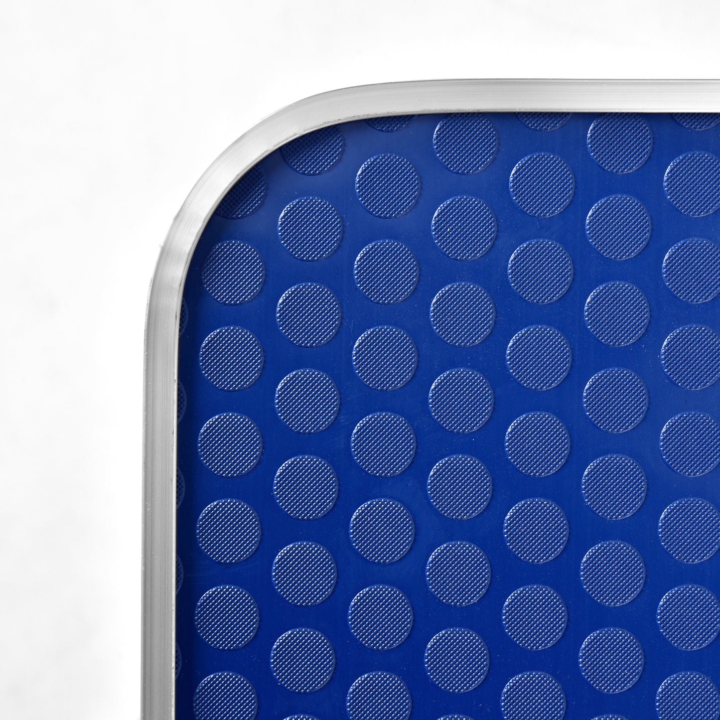 Closeup of a blue mat with raised circular textured patterns perfect for grip
