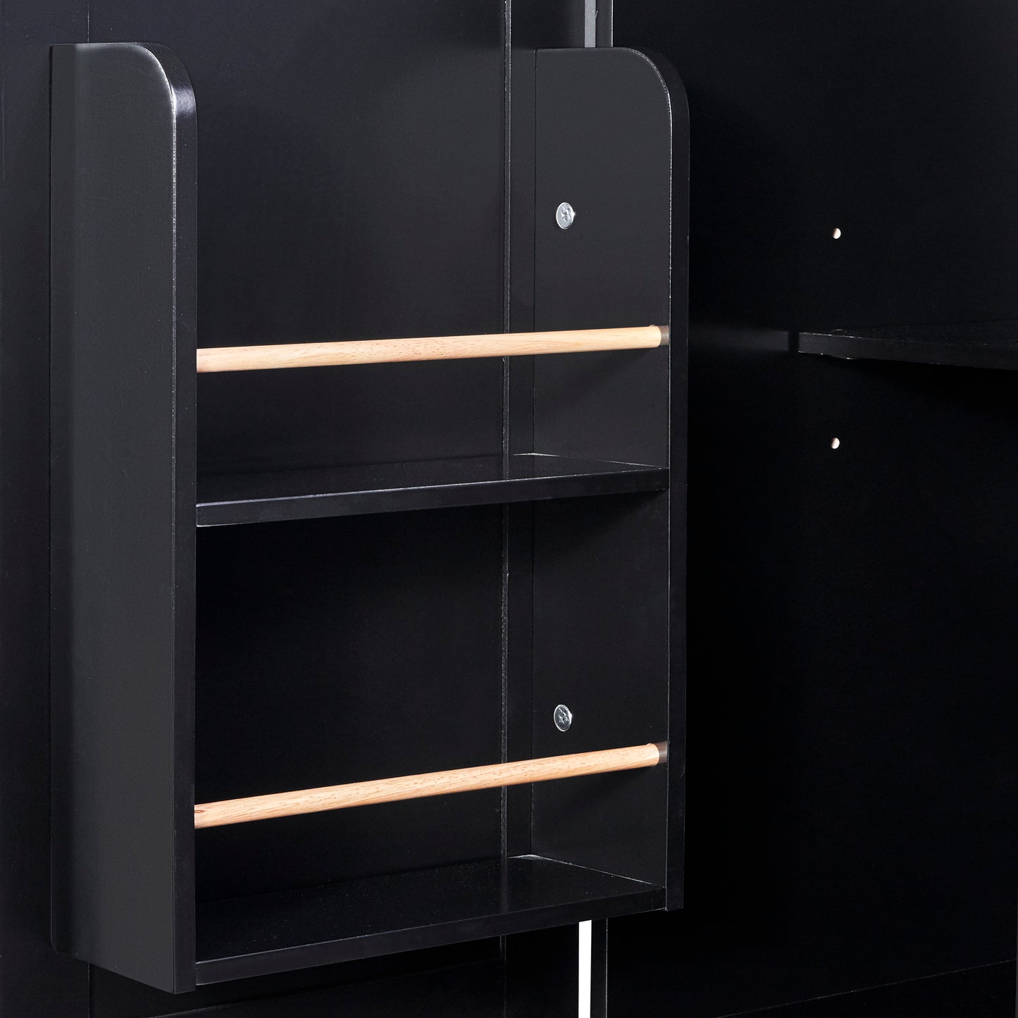 Closeup of a black wooden shelf unit with two parallel wooden dowels supporting shelves