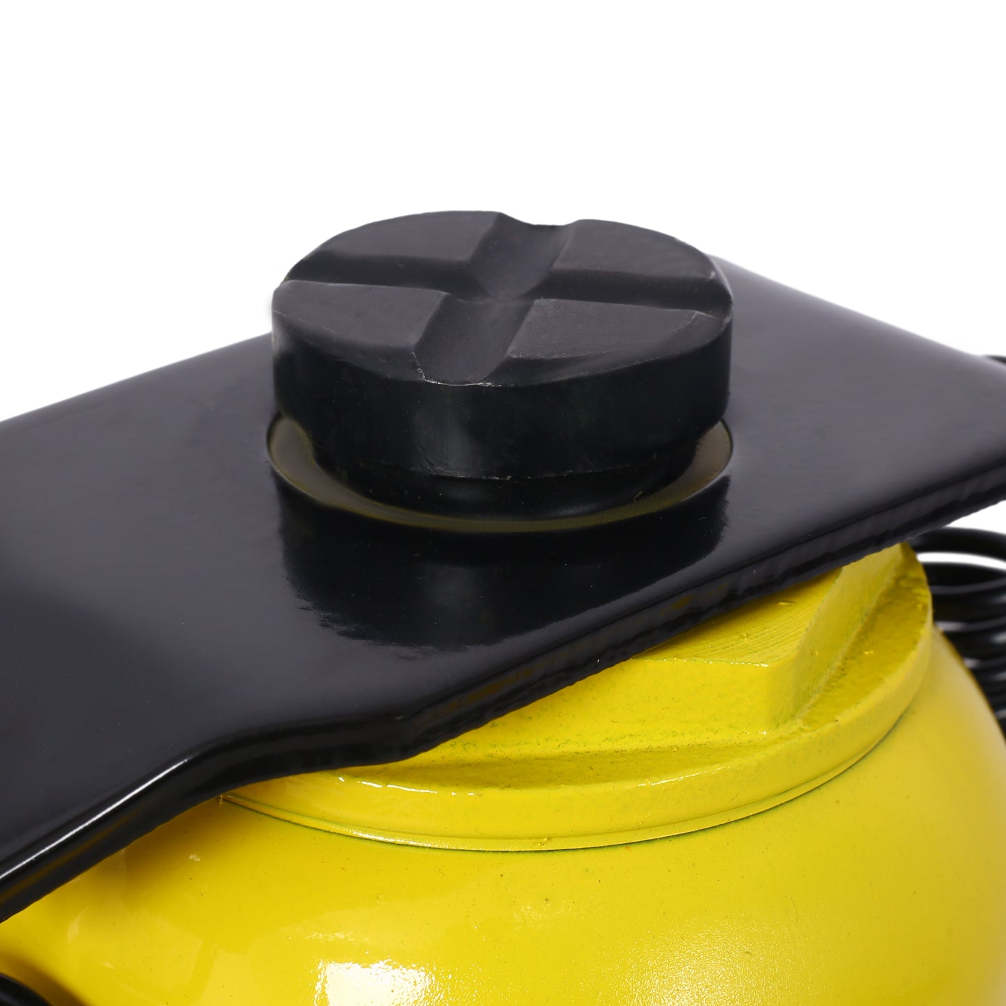Closeup of a yellow hydraulic jacks lifting pad and black steel saddle