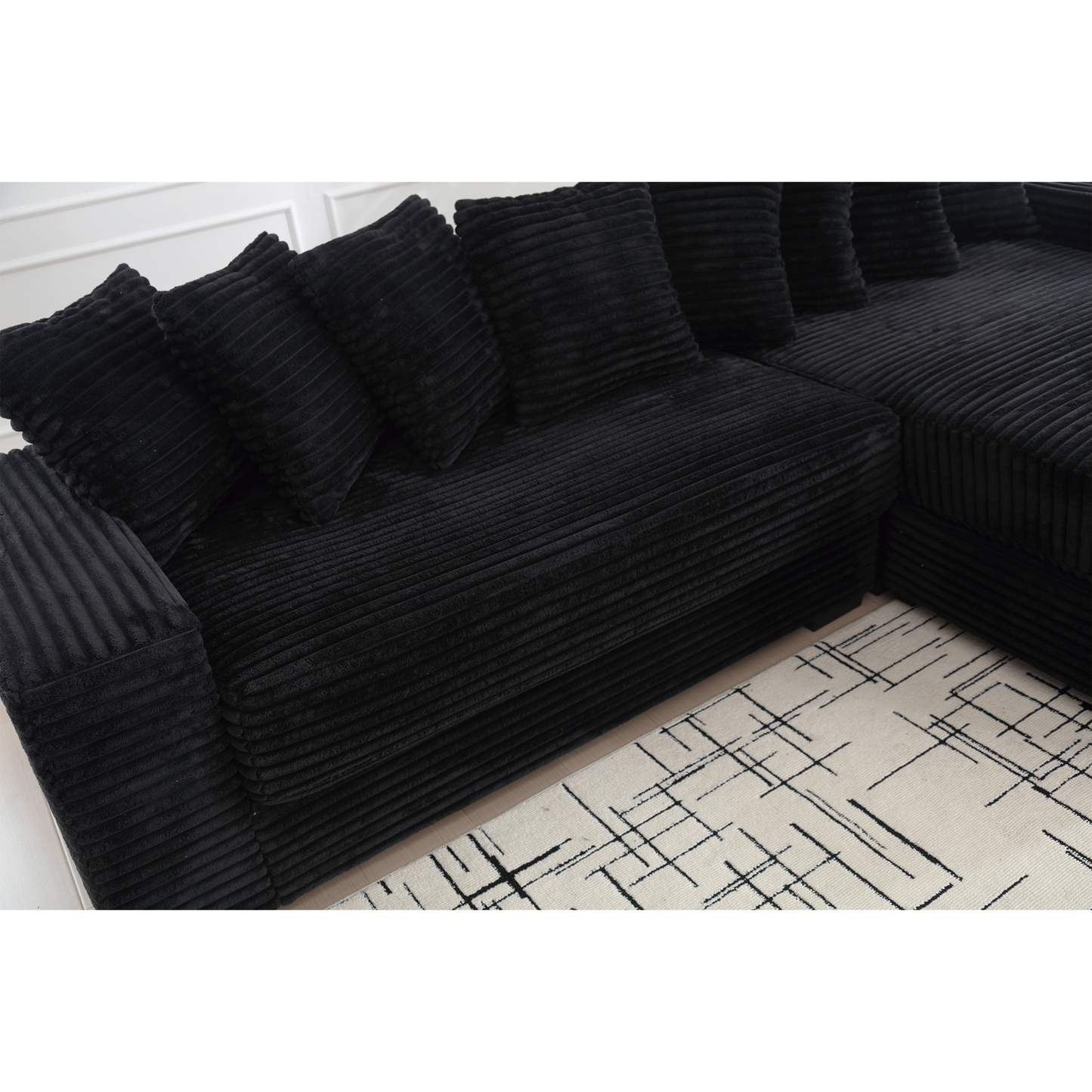 Black corduroy sectional sofa with plush cushions ideal for modern living rooms