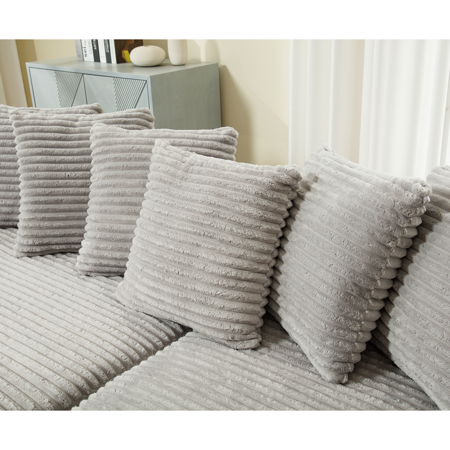 Plush corduroy throw pillows in light grey offering comfort and style to modern sofas