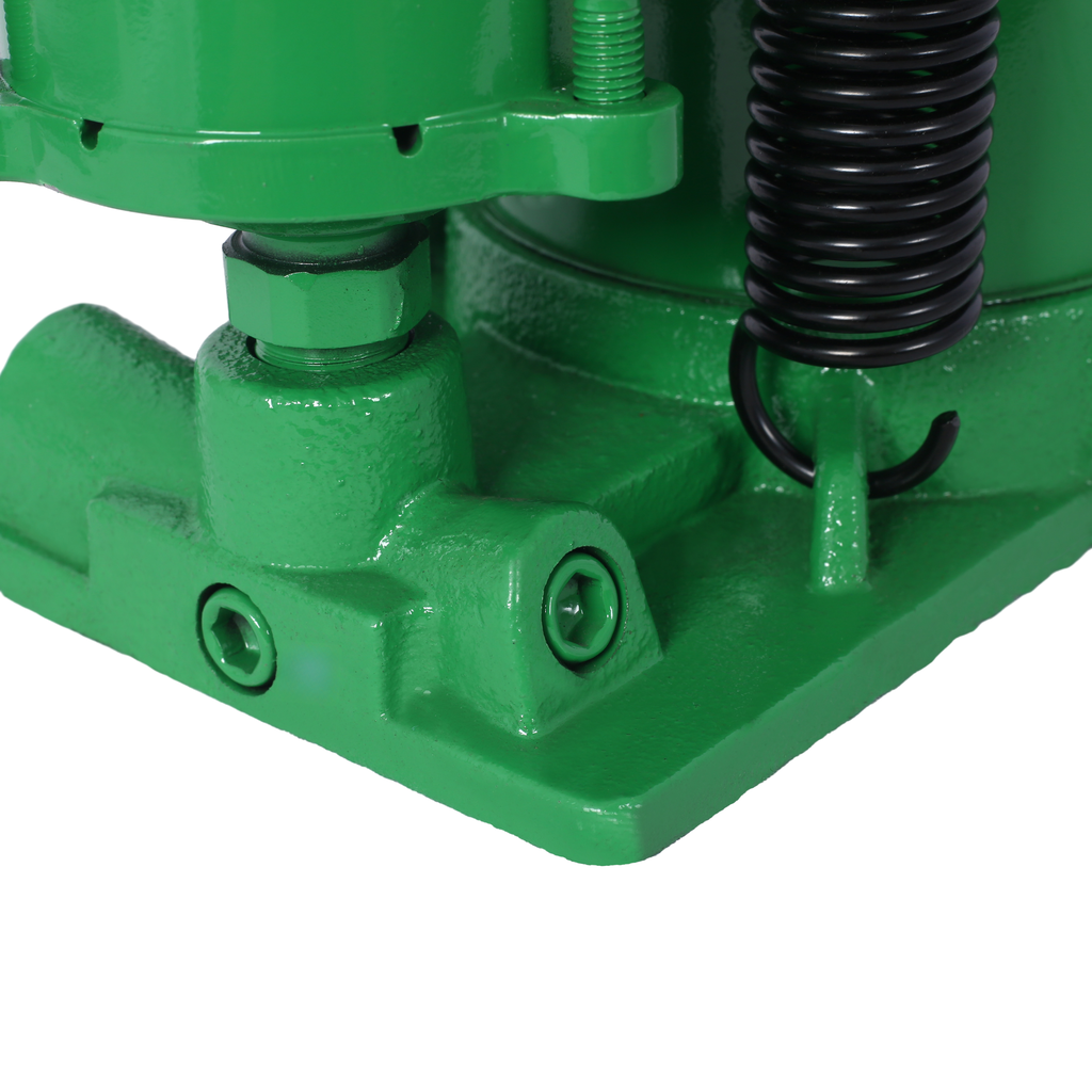 Closeup of green hydraulic jack base with black spring attachment and hex bolts