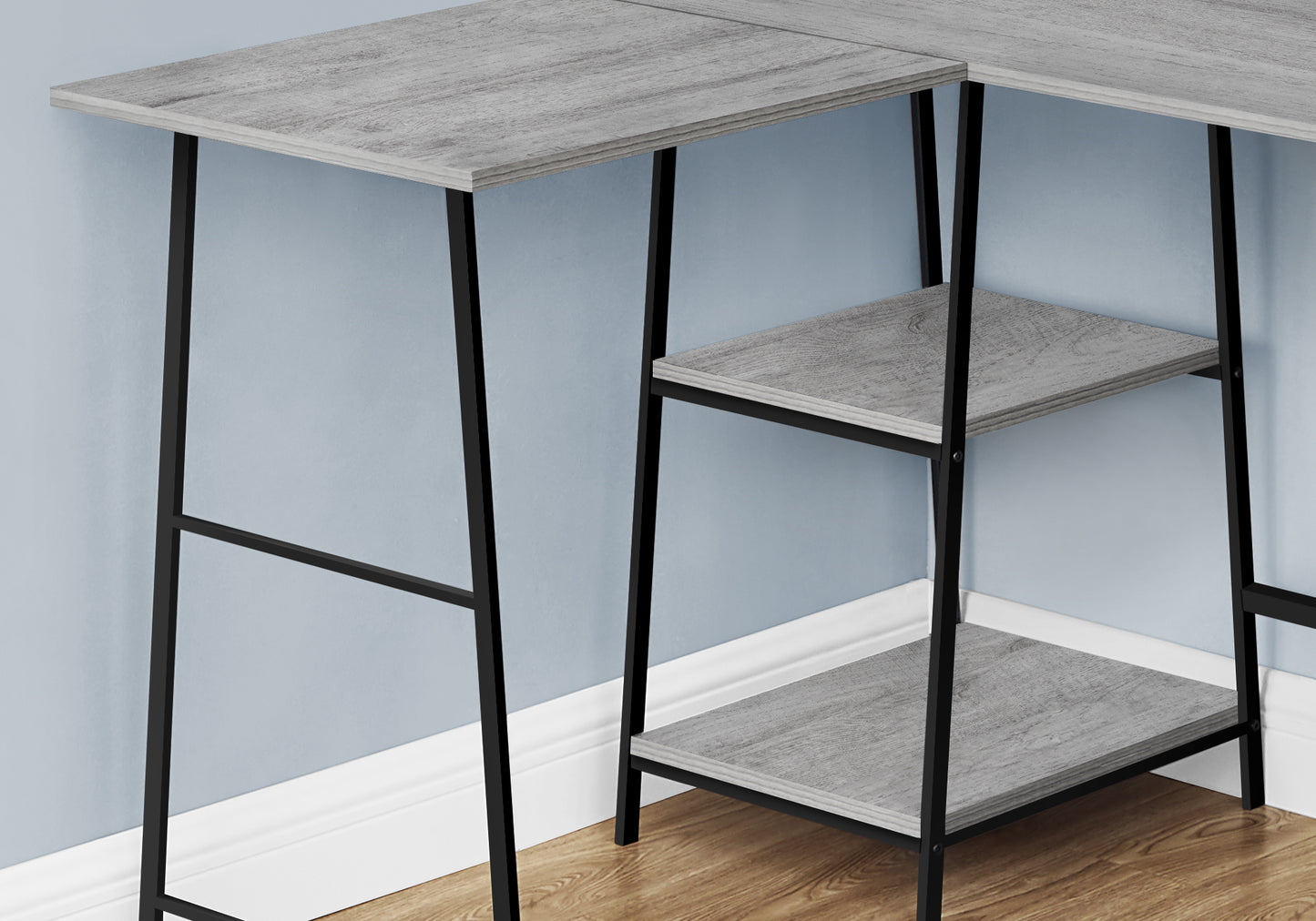 Grey wood corner desk with two shelves and black metal legs for a modern office