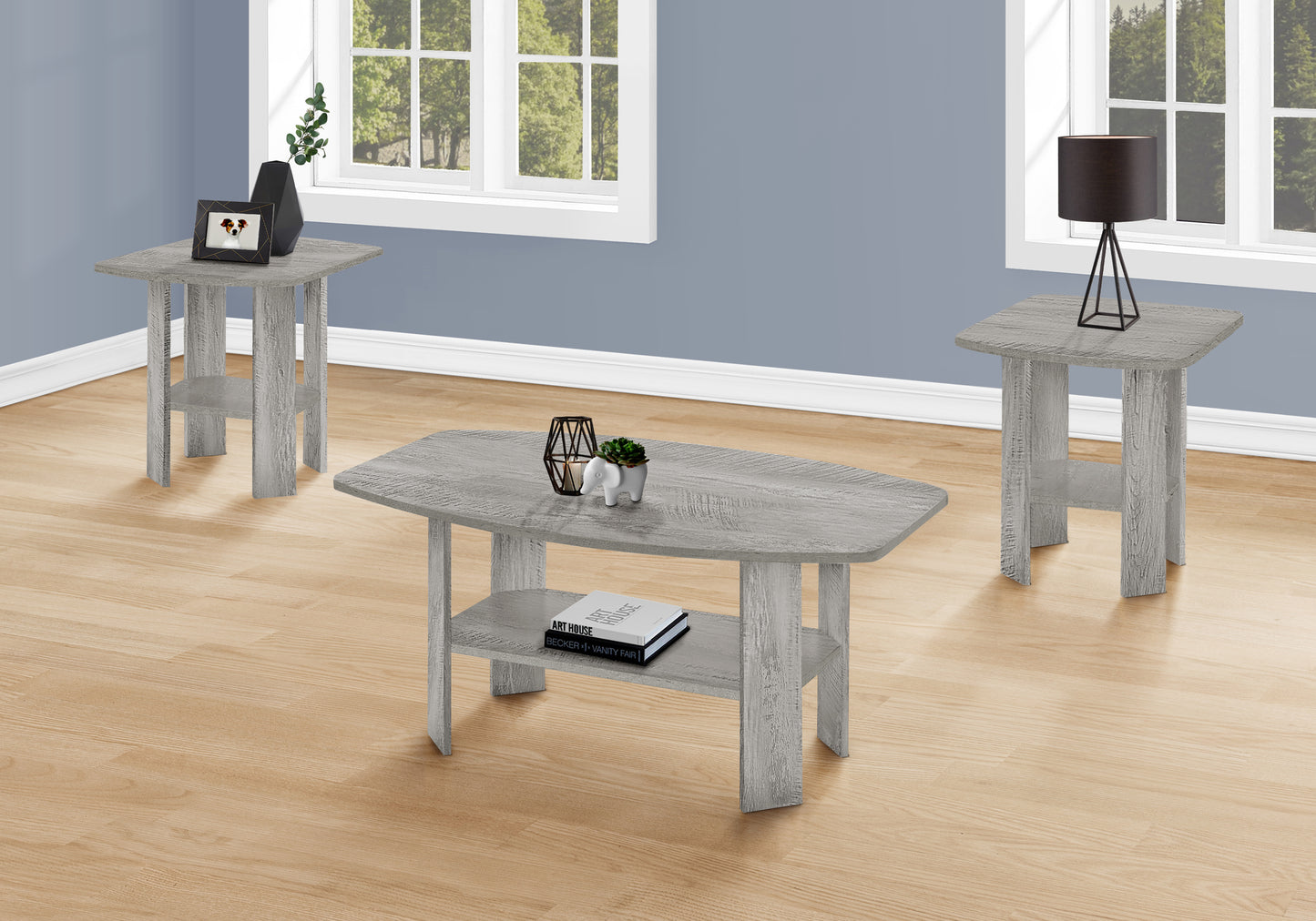 Rustic grey wood coffee table with lower shelf holding books