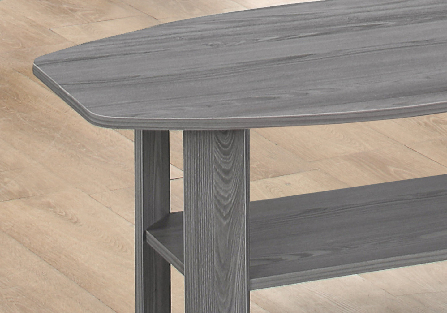 Gray wood grain coffee table with rounded edges and two open shelves for storage