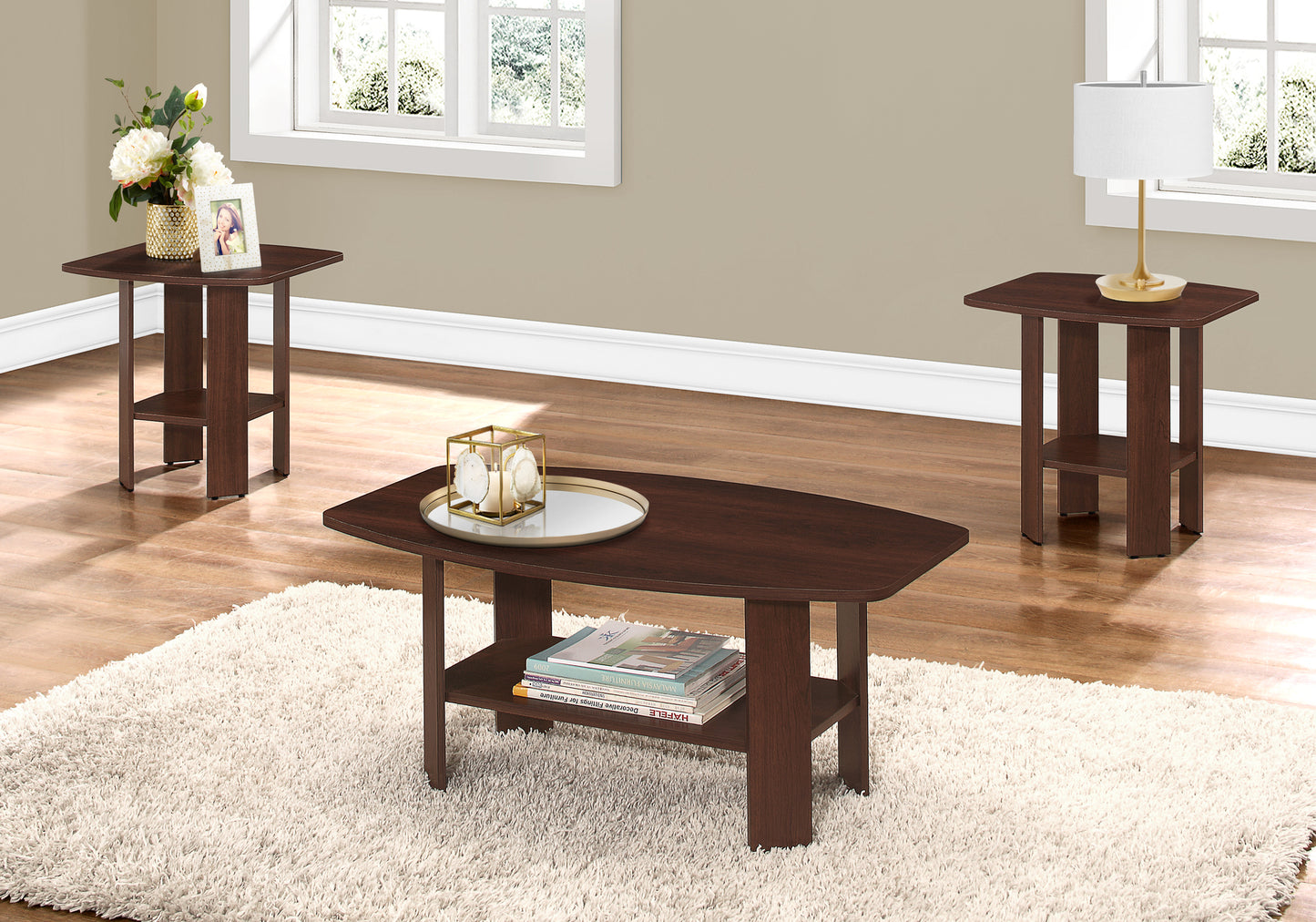 Dark wood oval coffee table with lower shelf and decorative tray