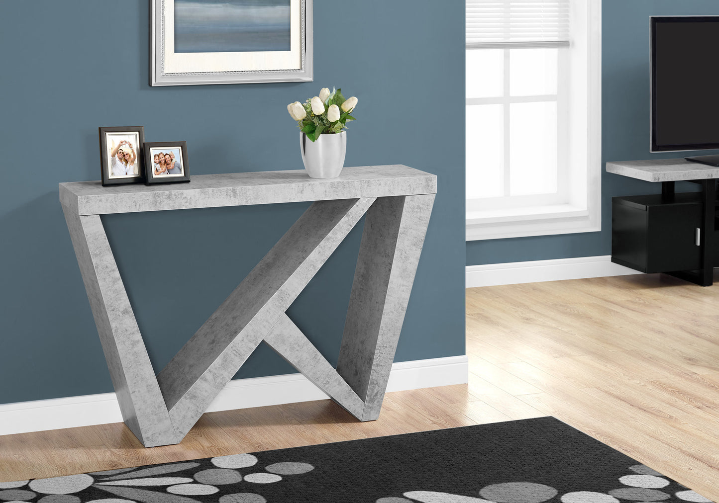 Modern gray concrete console table with geometric legs and a faux marble top