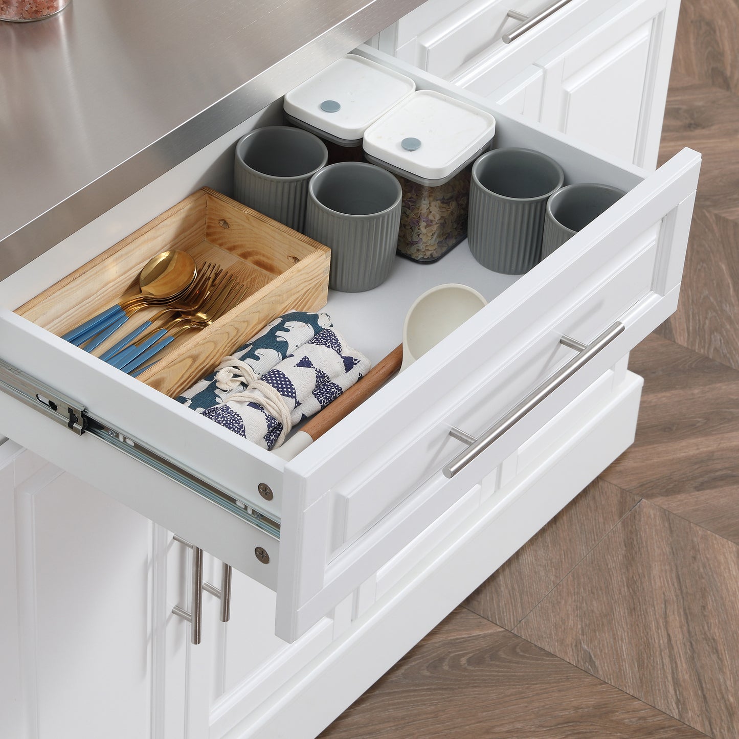 Gold flatware with blue handles in wooden organizer tray