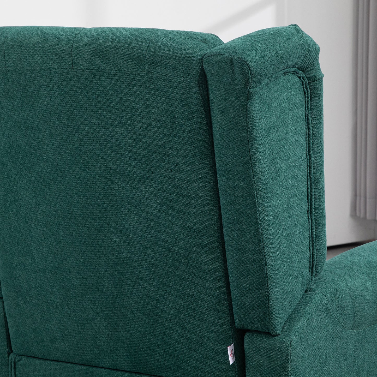 Dark green fabric sofa detail with plush texture and stitching for living room comfort