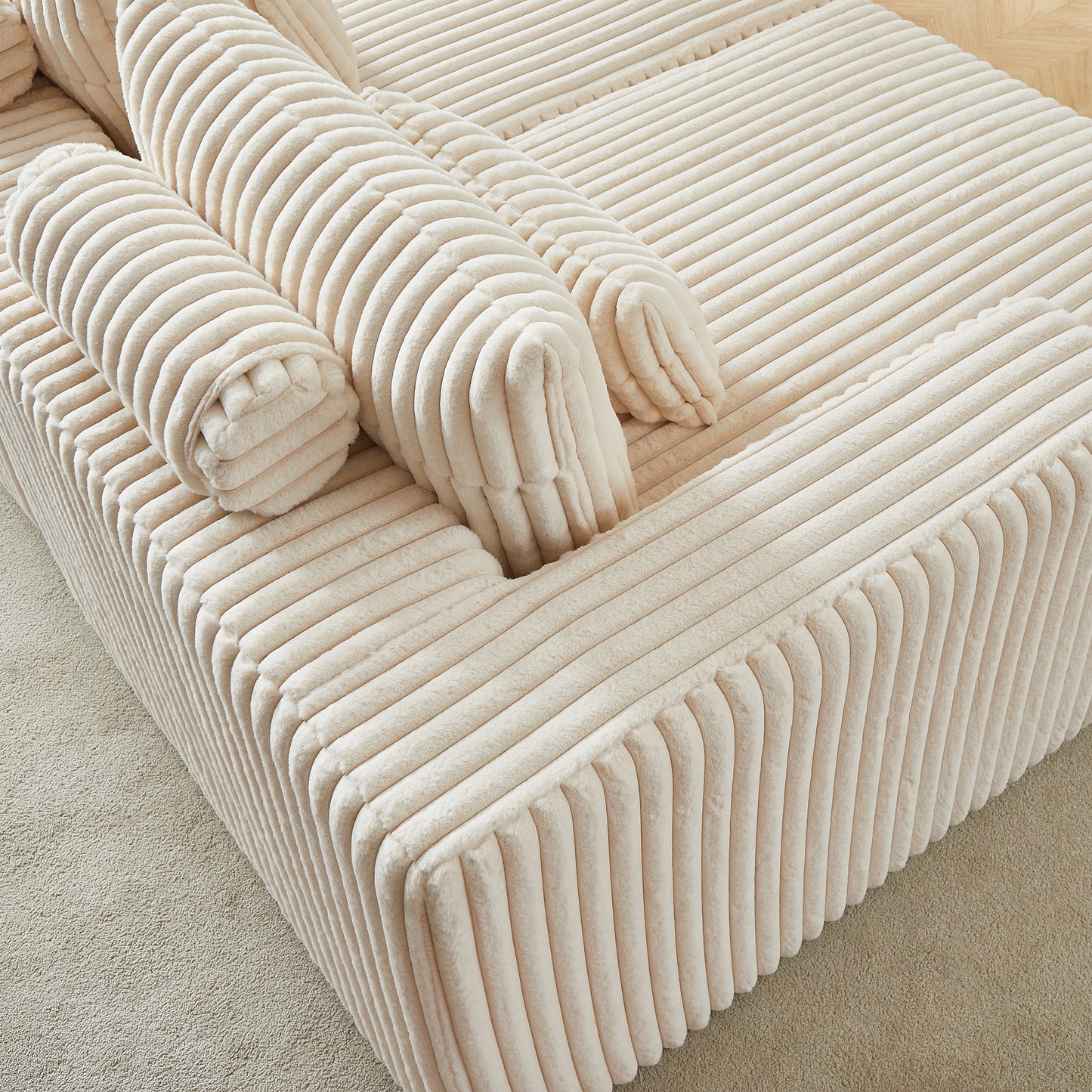 Plush cream corduroy sectional sofa with tufted bolster pillows for ultimate comfort