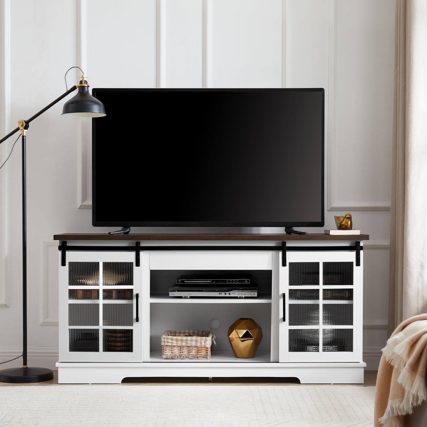 White sliding barn door tv stand with dark wood top and glass cabinet doors
