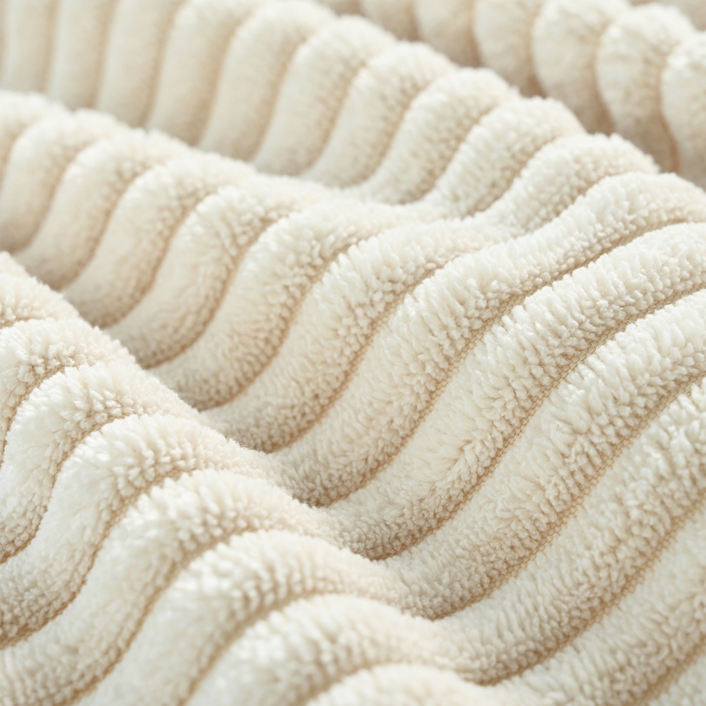 Plush cream sherpa fabric with vertical ribbed texture perfect for cozy blankets