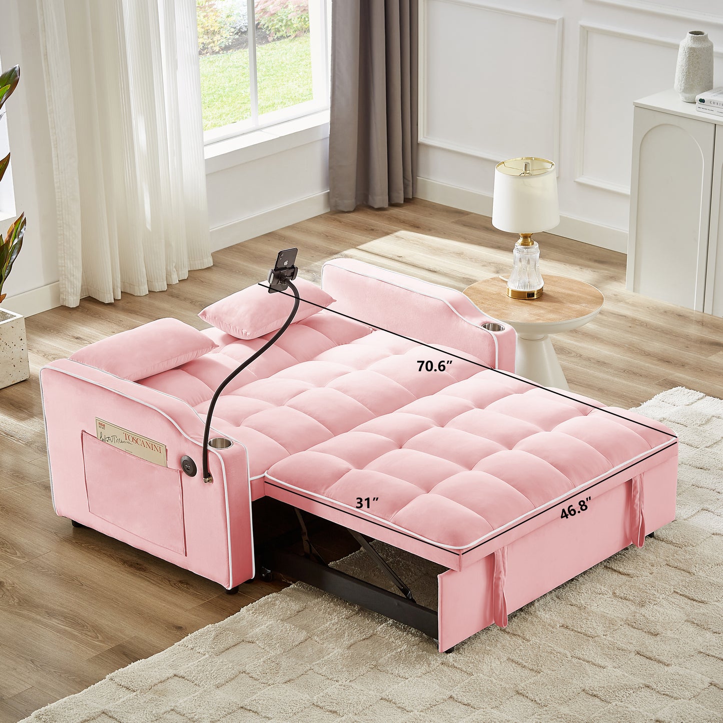 Pink velvet sofa bed with tufted cushions and phone holder measuring unfolded